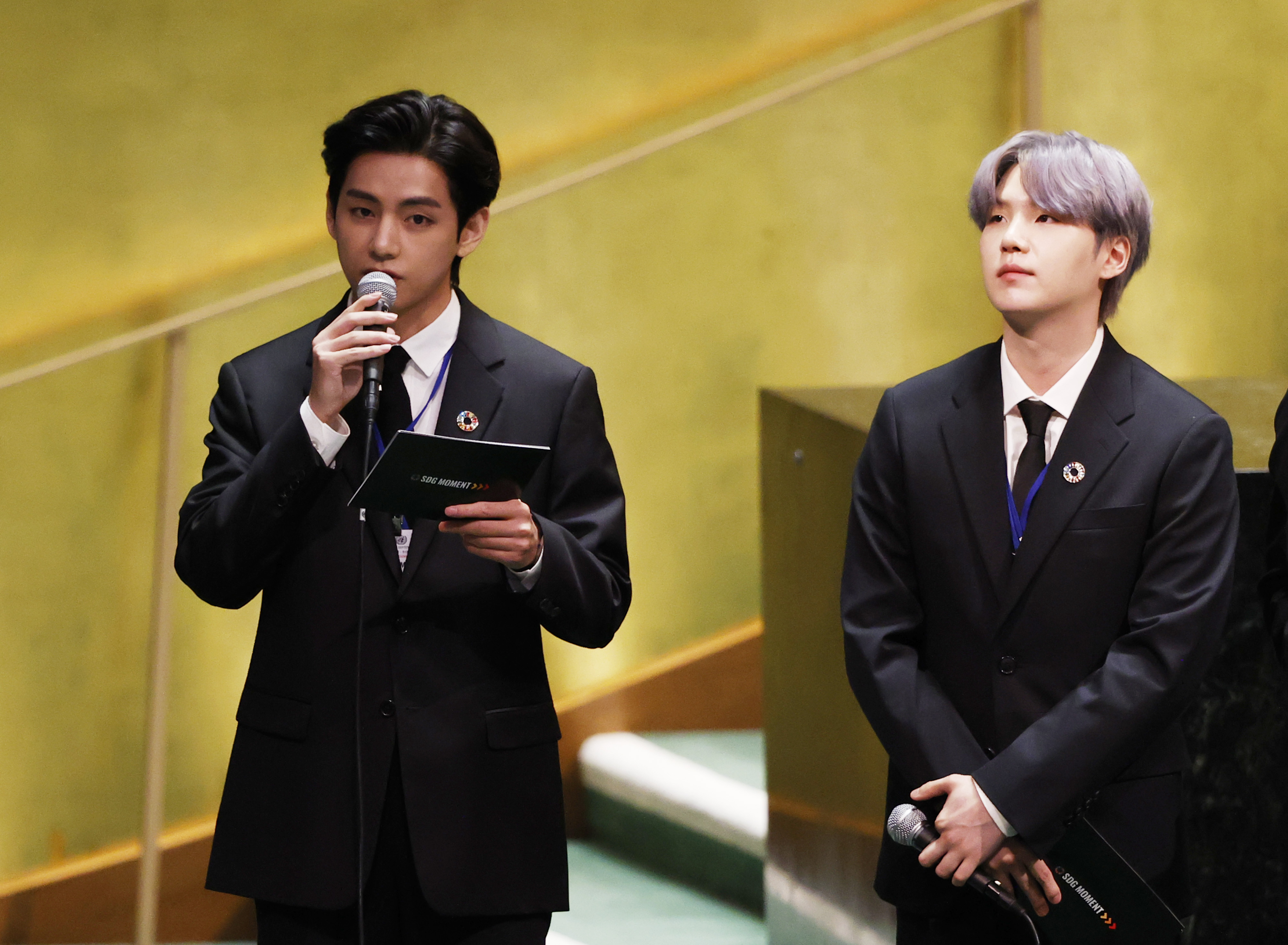 Suga listens as Taehyung/V of South Korean boy band BTS speaks at the SDG Moment event as part of the UN General Assembly 76th session