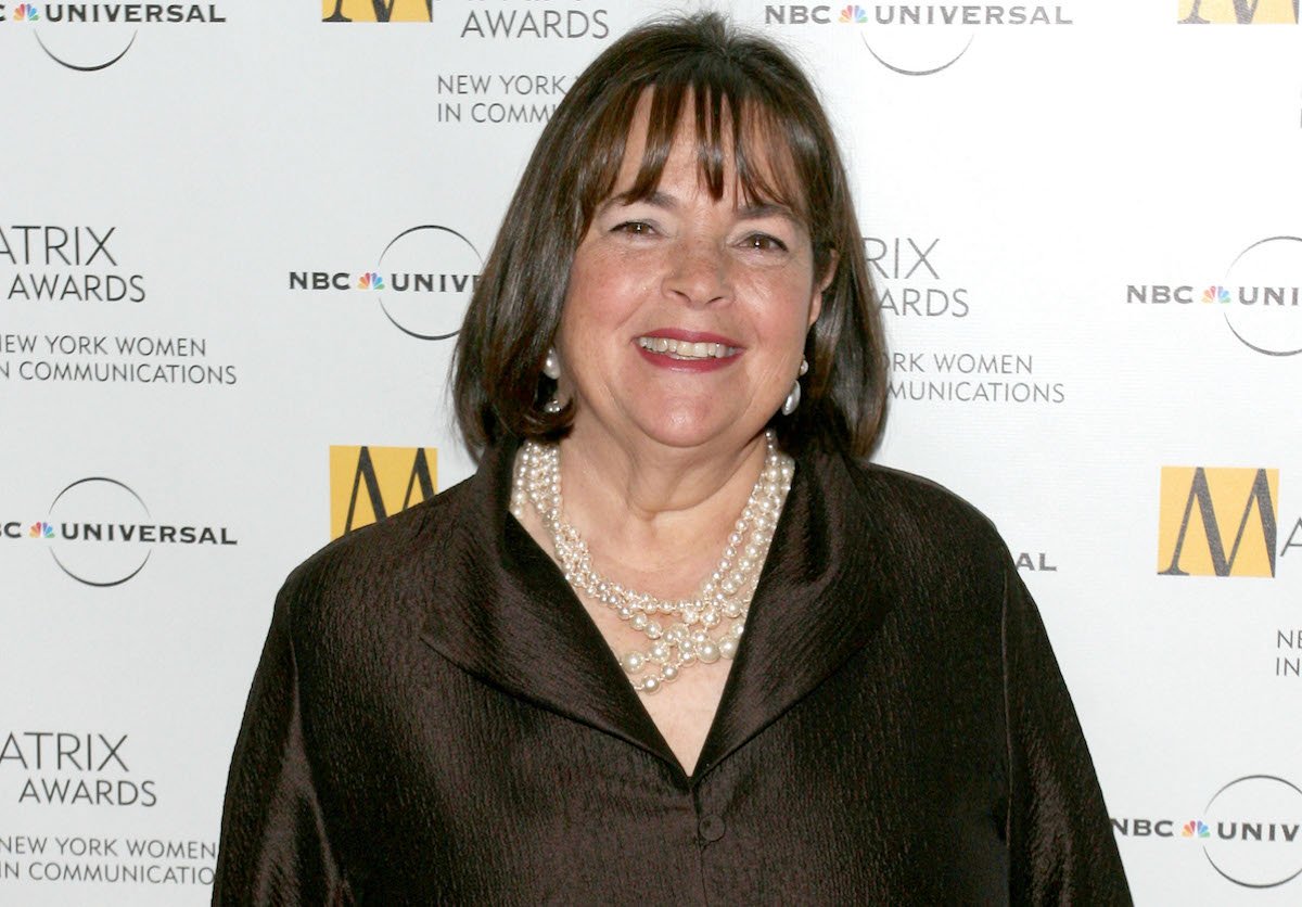 Barefoot Contessa Ina Garten smiles wearing pearl necklaces and a brown shirt