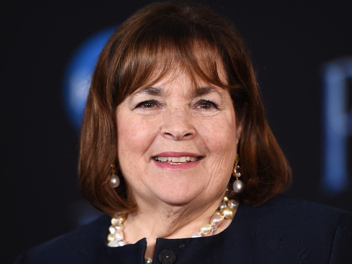 Ina Garten smiles wearing a black shirt and pearl necklace