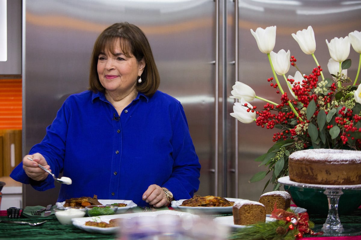 Barefoot Contessa Ina Garten holds a spoon and looks on wearing a blue shirt during a cooking demonstration