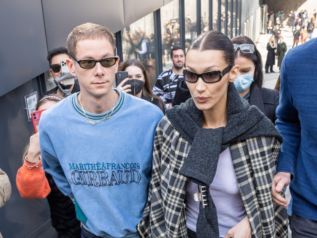 Bella Hadid and Marc Kalman pass paparazzi as the couple tries to exit during the Milan Fashion Week Fall/Winter 2022/2023