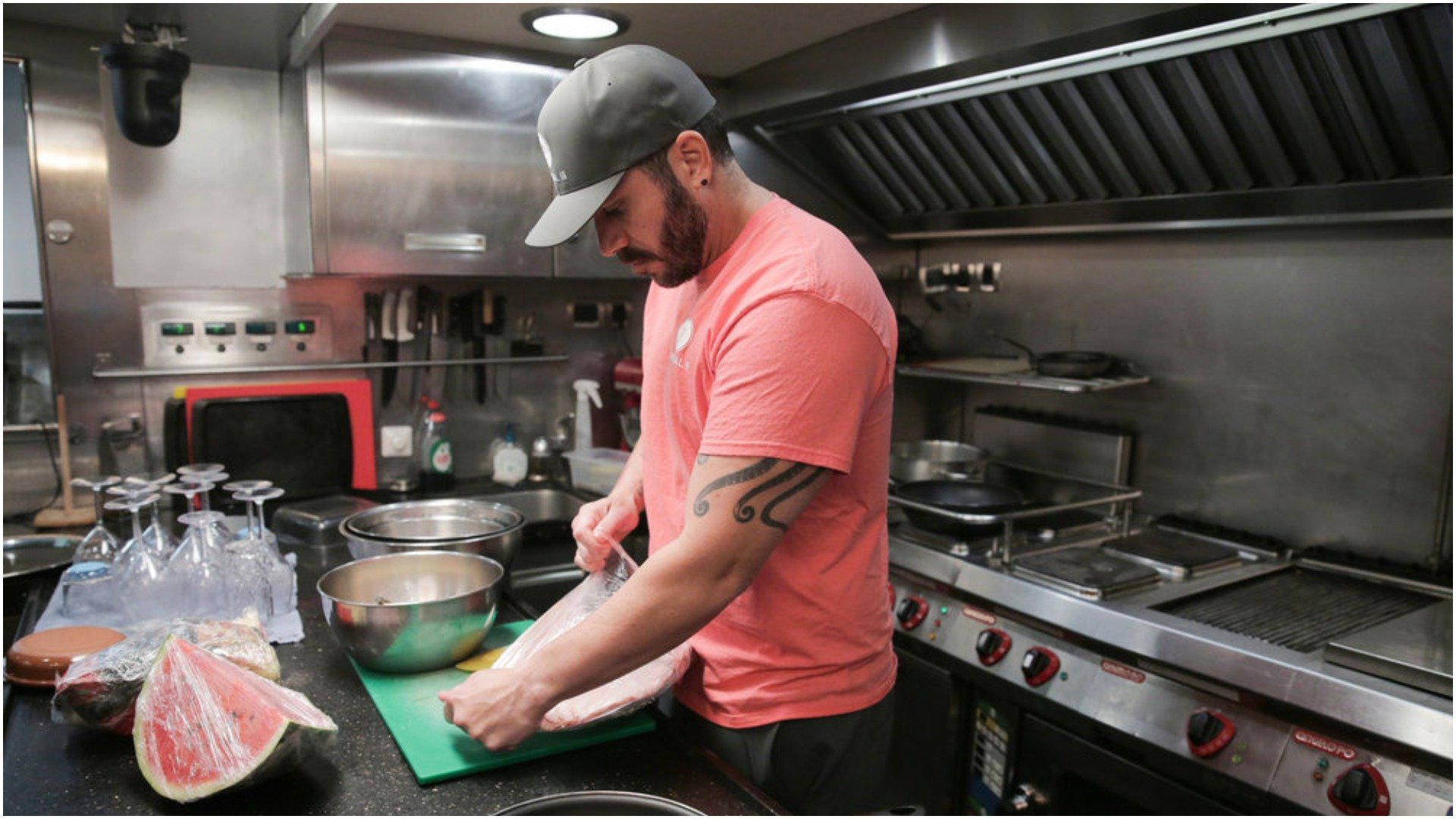 Chef Marcos Spaziani from 'Below Deck Sailing Yacht' prepares a meal in the galley kitchen 