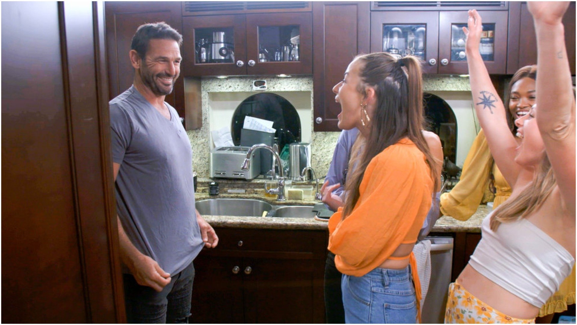 Captain Jason Chambers shows Aesha Scott his t-shirt in the crew kitchen 