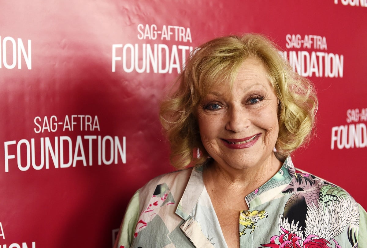 'The Young and the Restless' actor Beth Maitland wearing a white and pink floral blouse during a charity event.