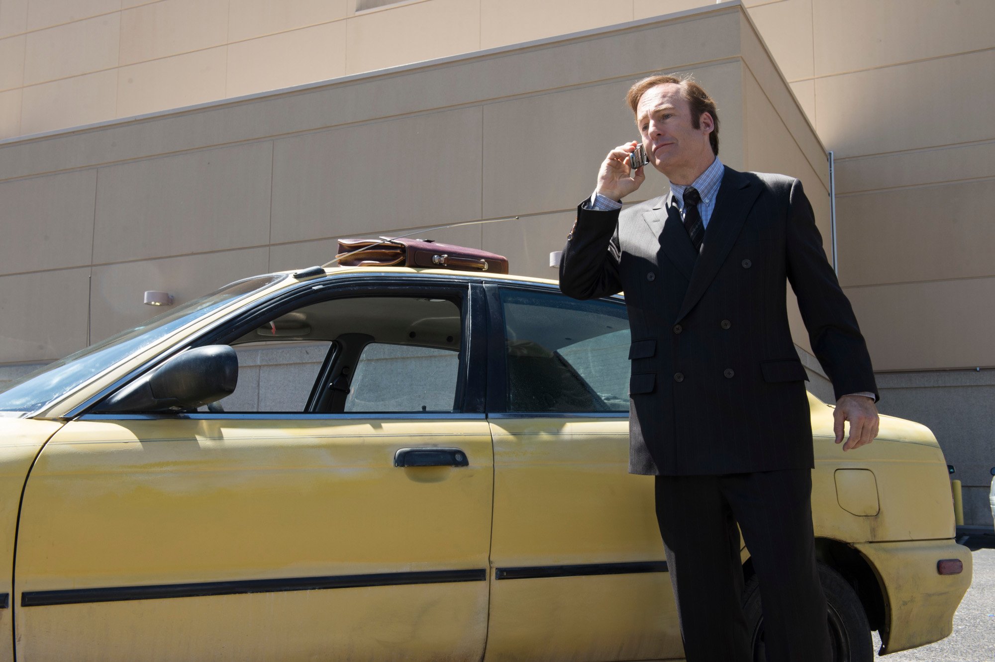 Bob Odenkirk as Jimmy McGill in 'Better Call Saul' Season 1 Episode 1. He's standing near his car and talking on his cellphone.