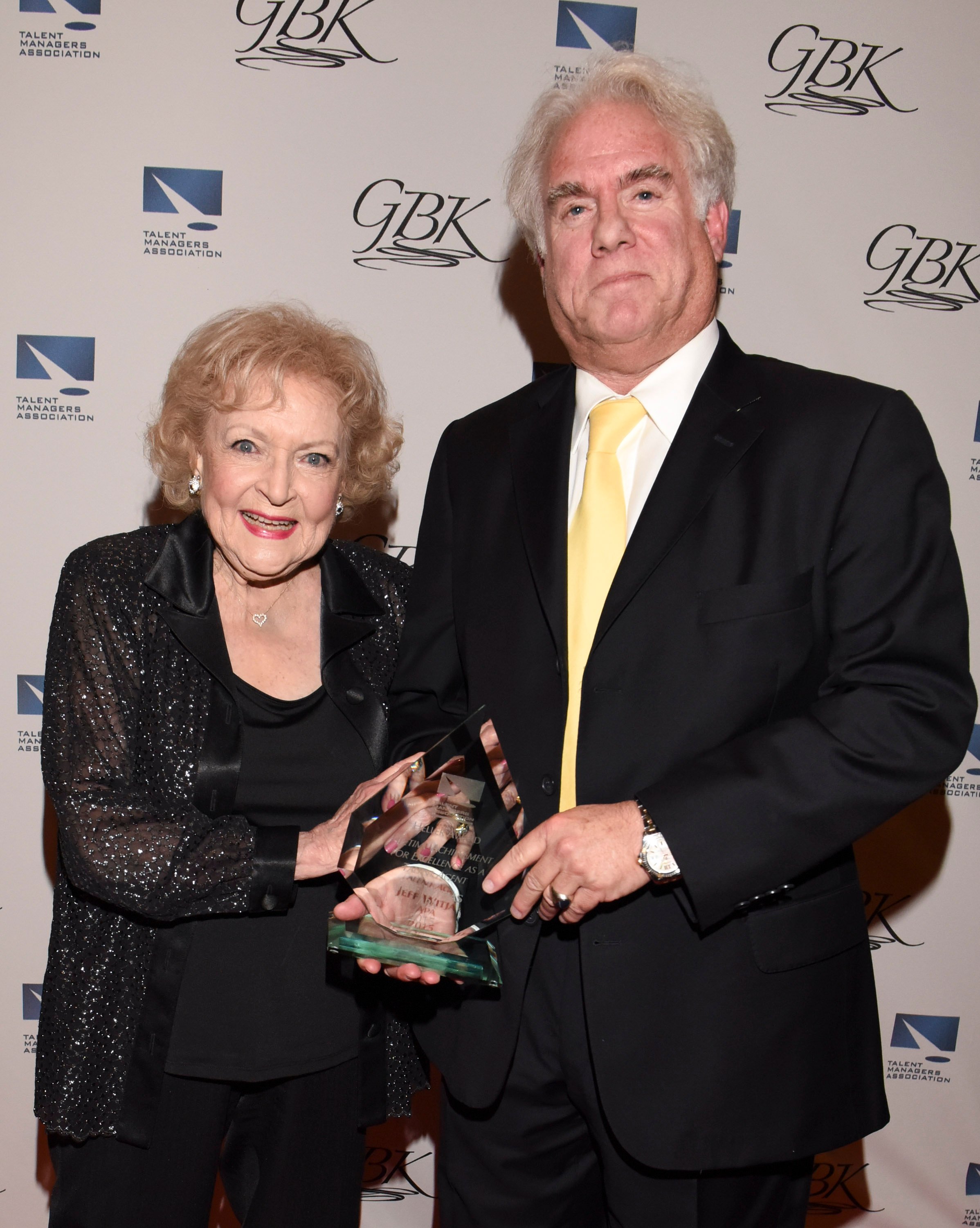 Betty White and her agent Jeff Witjas holding the actor's award at The TMA Heller Awards