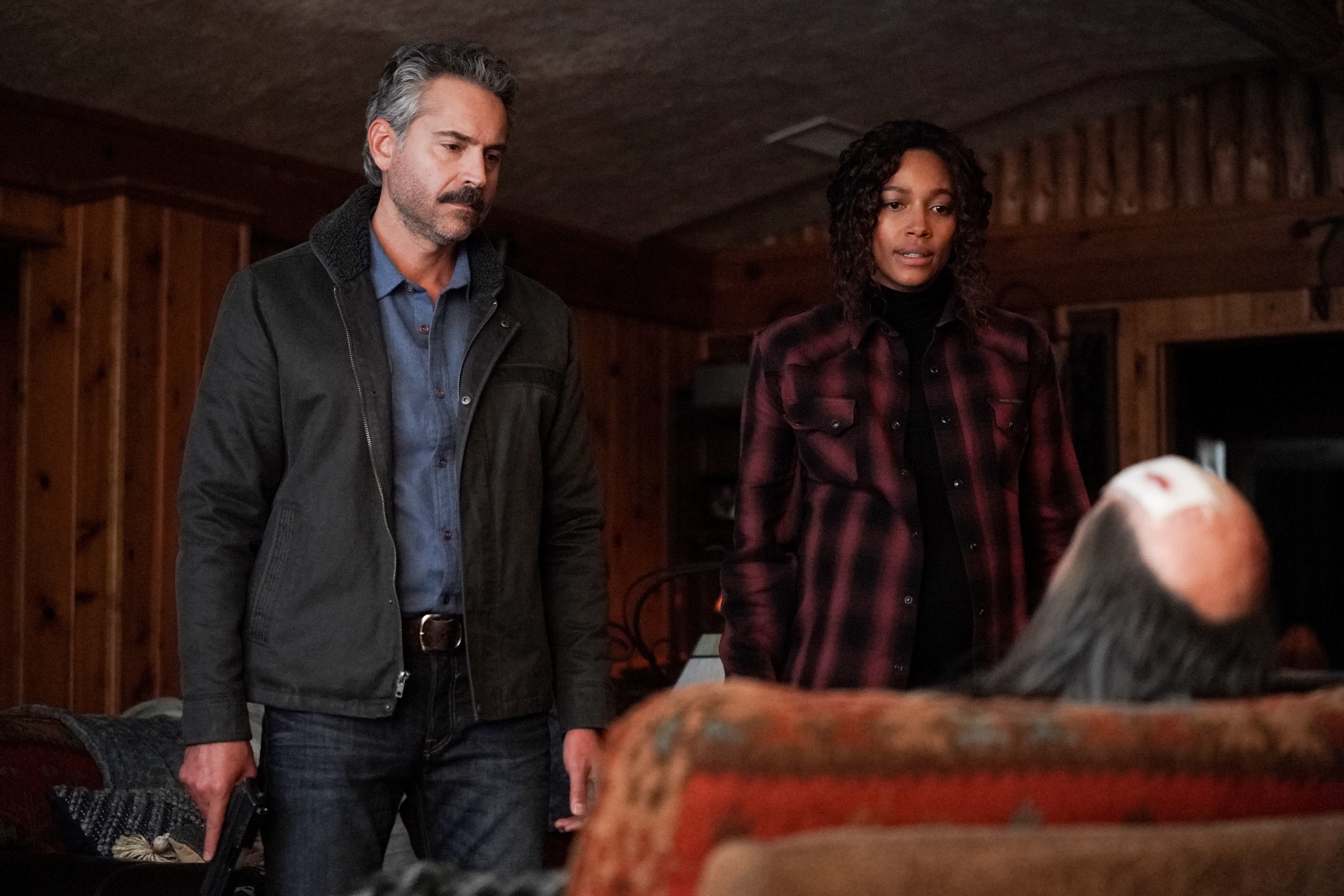 Omar Metwally and Kylie Bunbury as Mark Lindor and Cassie Dewell in 'Big Sky' staring at Wolf Legarski
