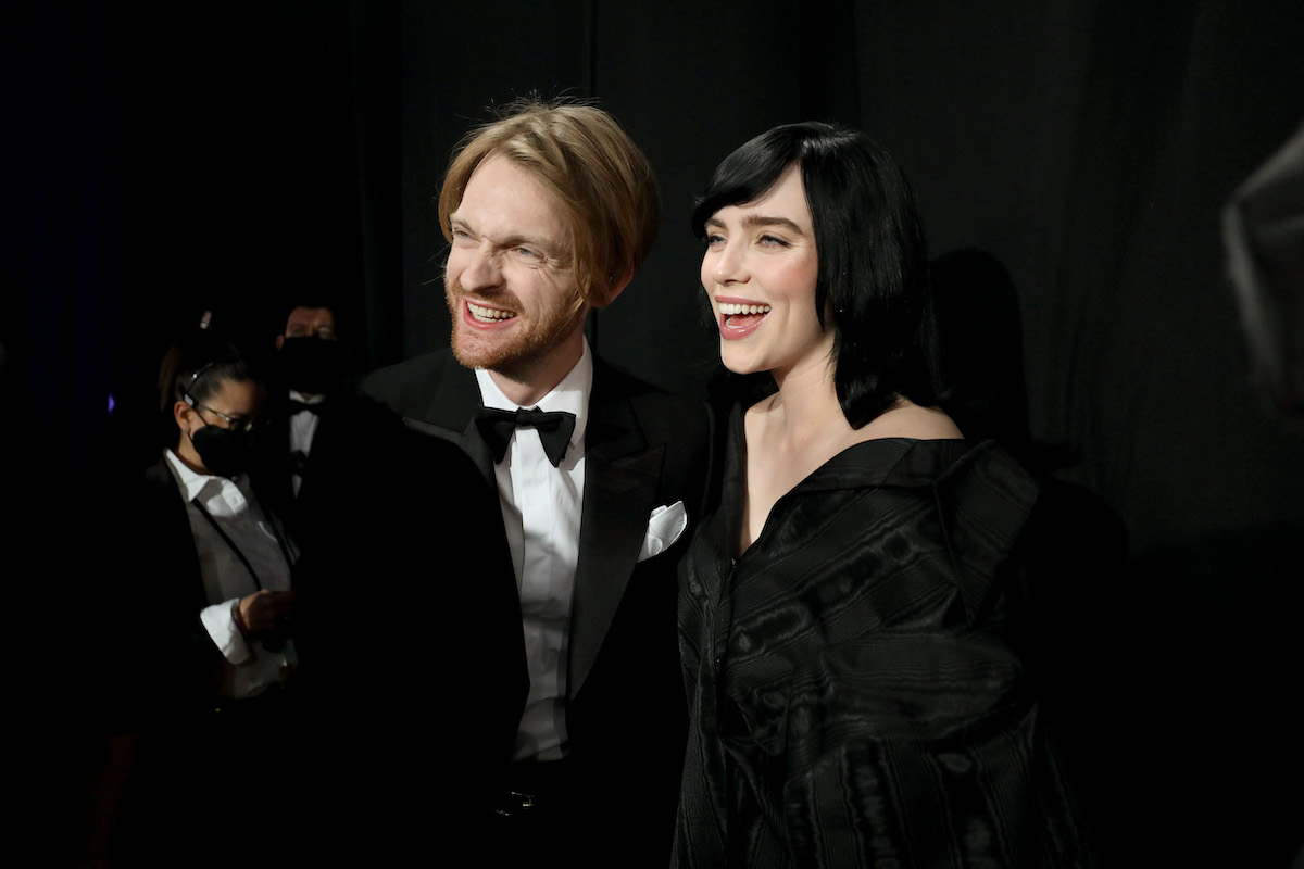 Billie Eilish (R) and FINNEAS are stand backstage during the 94th Annual Academy Awards