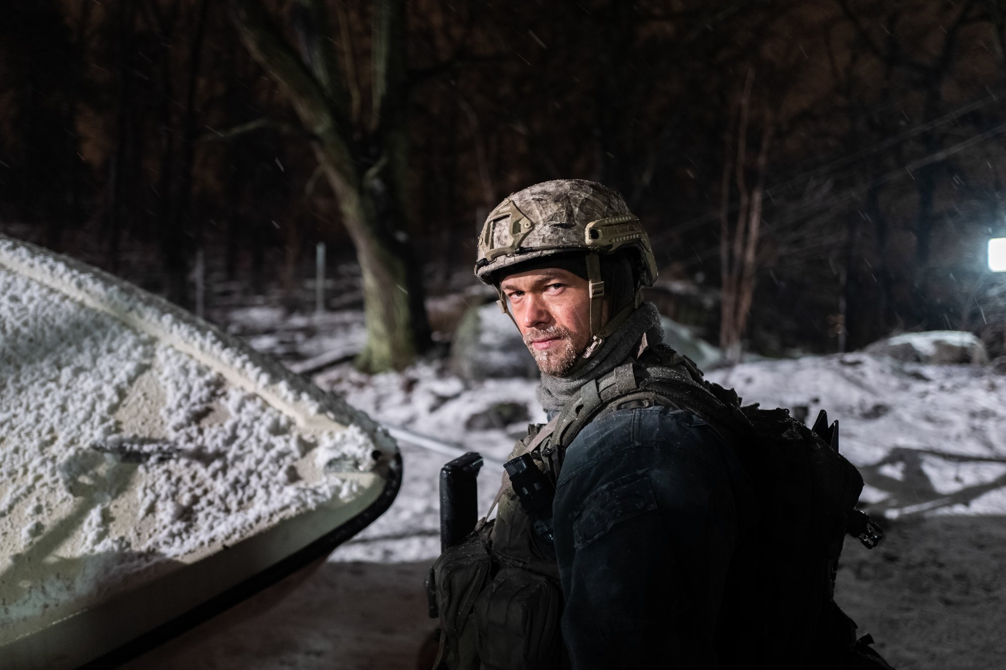 'Black Crab' Jakob Oftebro as Nylund looking behind wearing combat uniform in the snow