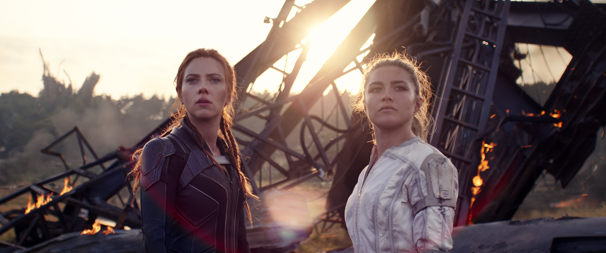 'Black Widow' Scarlett Johansson as Natasha Romanoff and Florence Pugh as Yelena Belova wearing Black Widow costumes in front of rubble