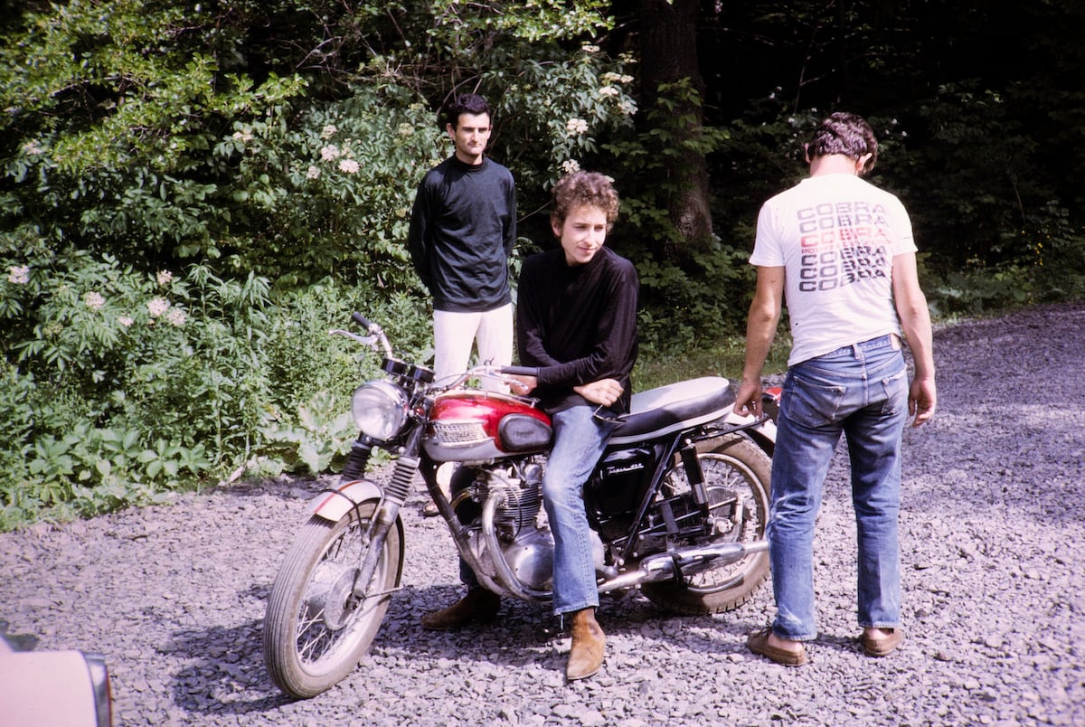 Bob Dylan sits on his motorcycle in 1964