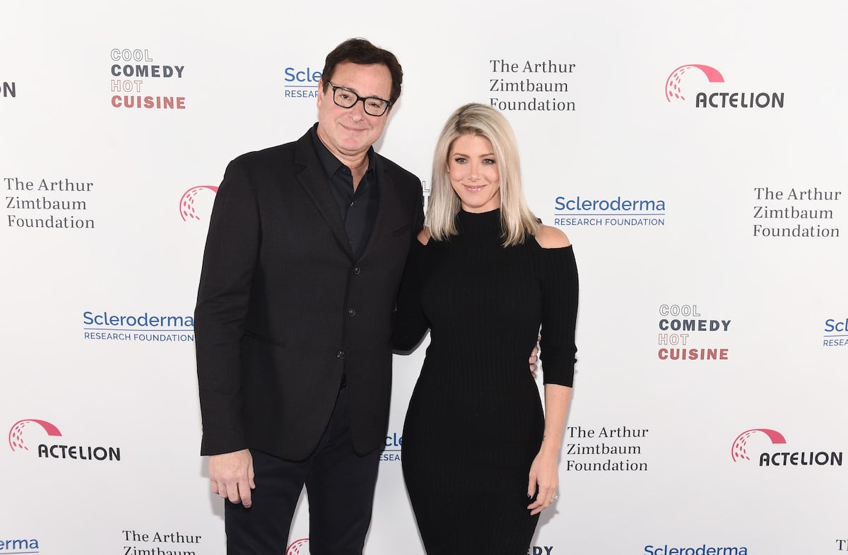 Bob Saget and his wife Kelly Rizzo pose together at an event.