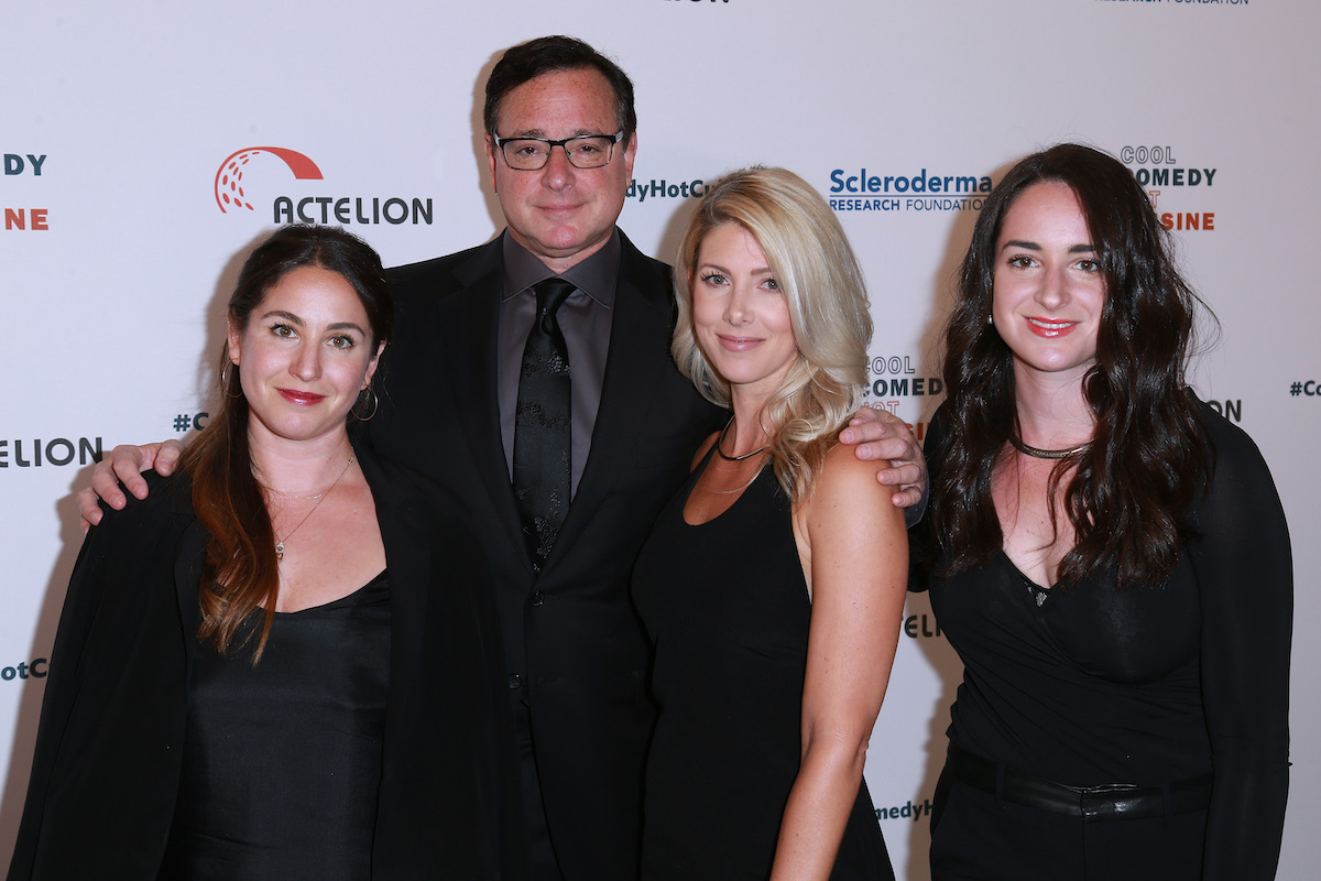 Aubrey Saget, Bob Saget, Kelly Rizzo, and Lara Saget pose together at an event.