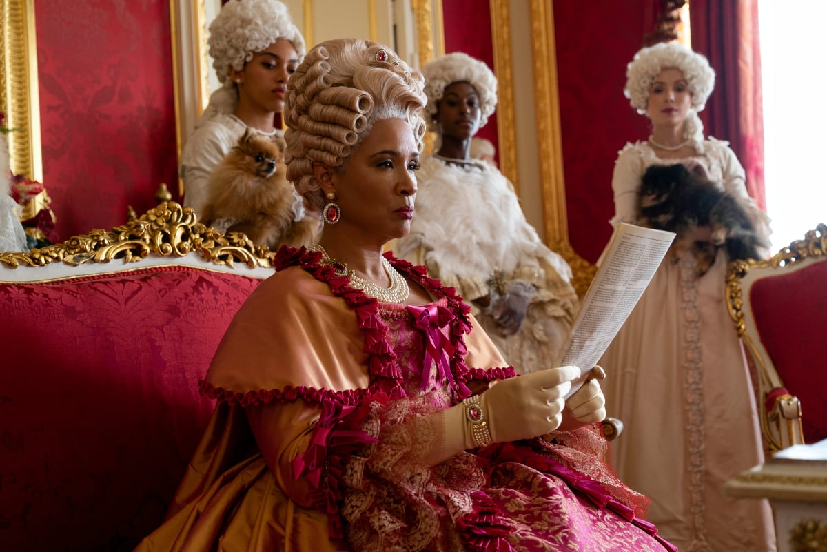 Golda Rosheuvel as Queen Charlotte reading Lady Whistledown's gossip about the ton in Bridgerton Season 2