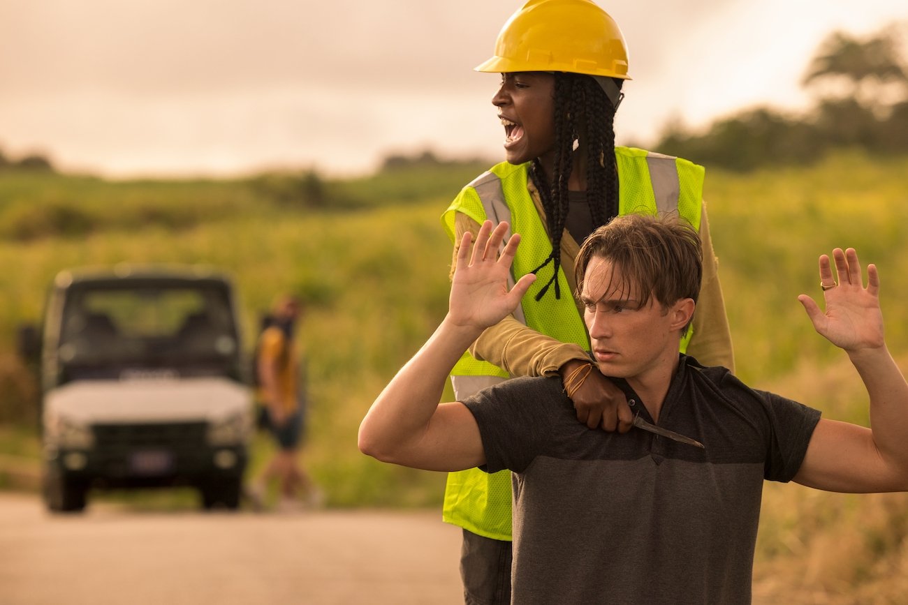 Cleo (Carlacia Grant) holds a knife to Rafe (Drew Starkey) in 'Outer Banks' Season 2