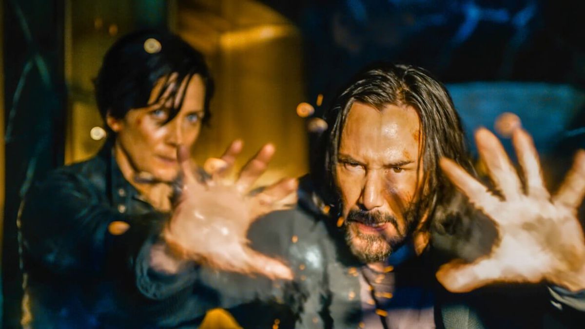 Trinity (Carrie-Anne Moss) and Neo (Keanu Reeves) fend off an attack in 'The Matrix Resurrections' | Warner Bros.