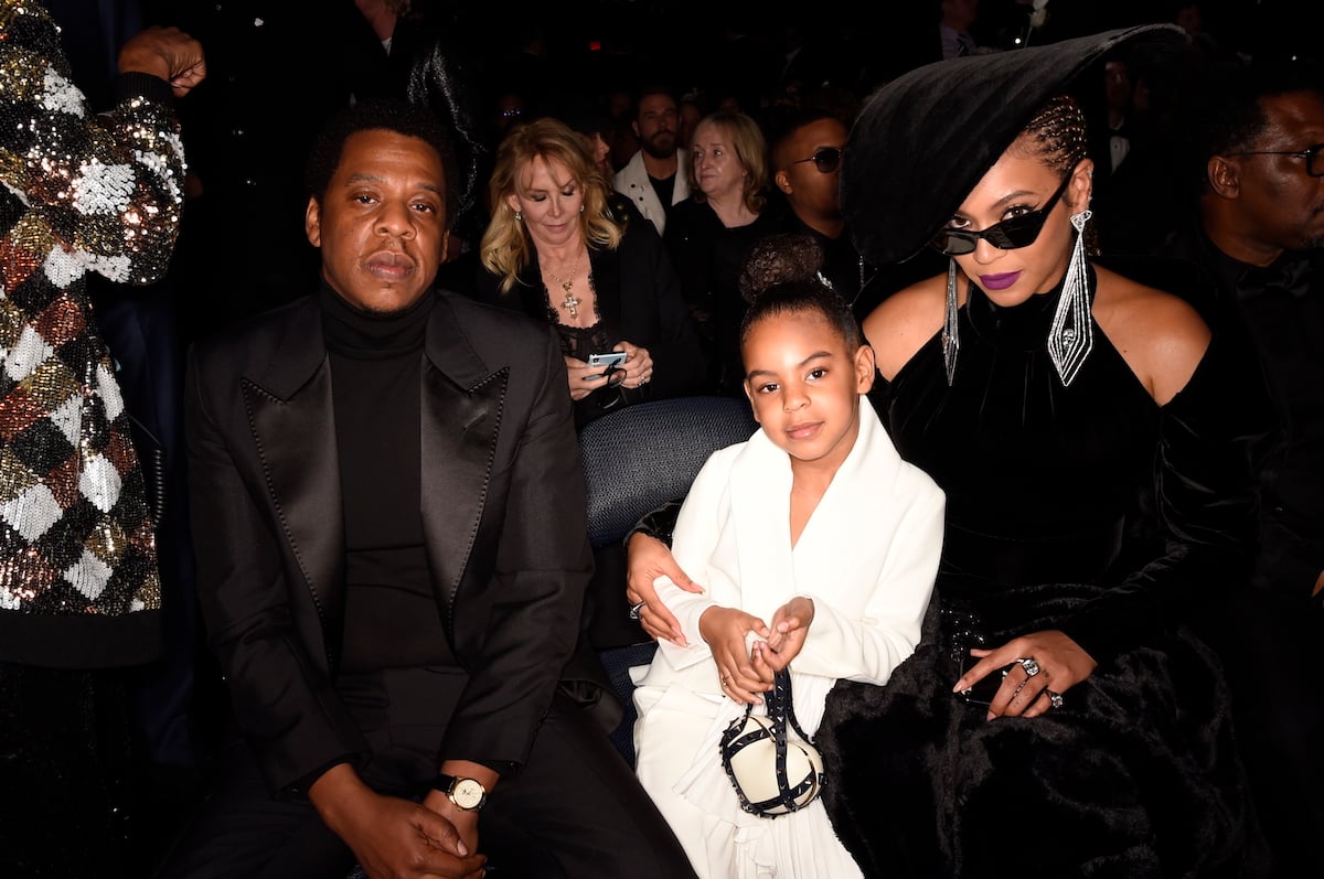 Jay-Z, Blue Ivy and Beyonce pose together at an event.