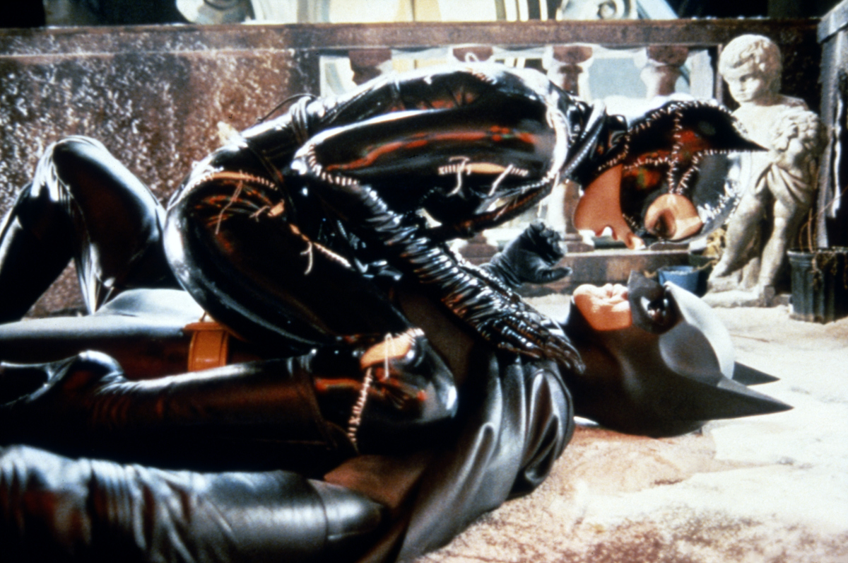 Michelle Pfeiffer’s Catwoman sits on top of Michael Keaton’s Batman in ‘Batman Returns’