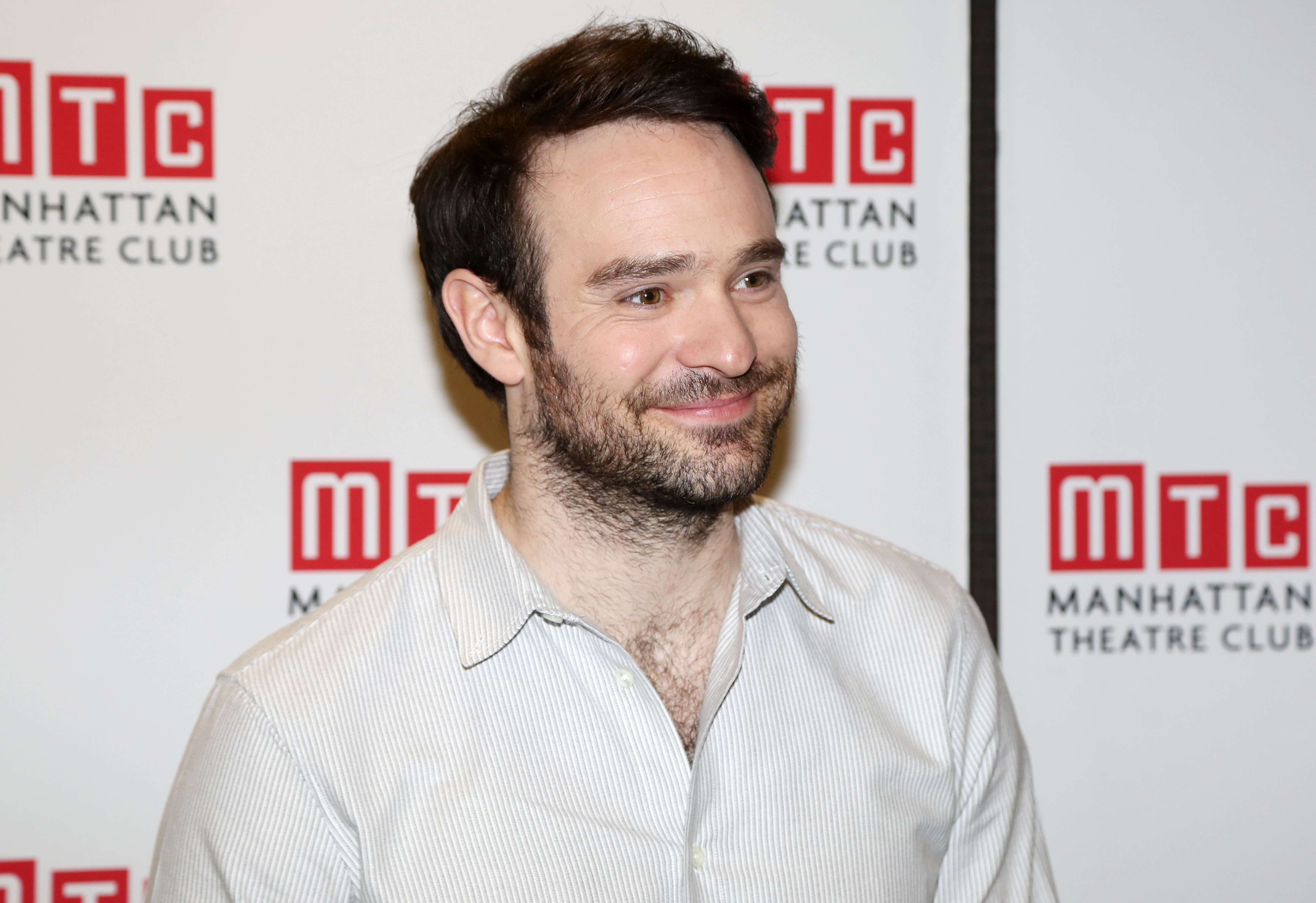Charlie Cox, star of 'Daredevil,' wears a white striped button-up shirt.