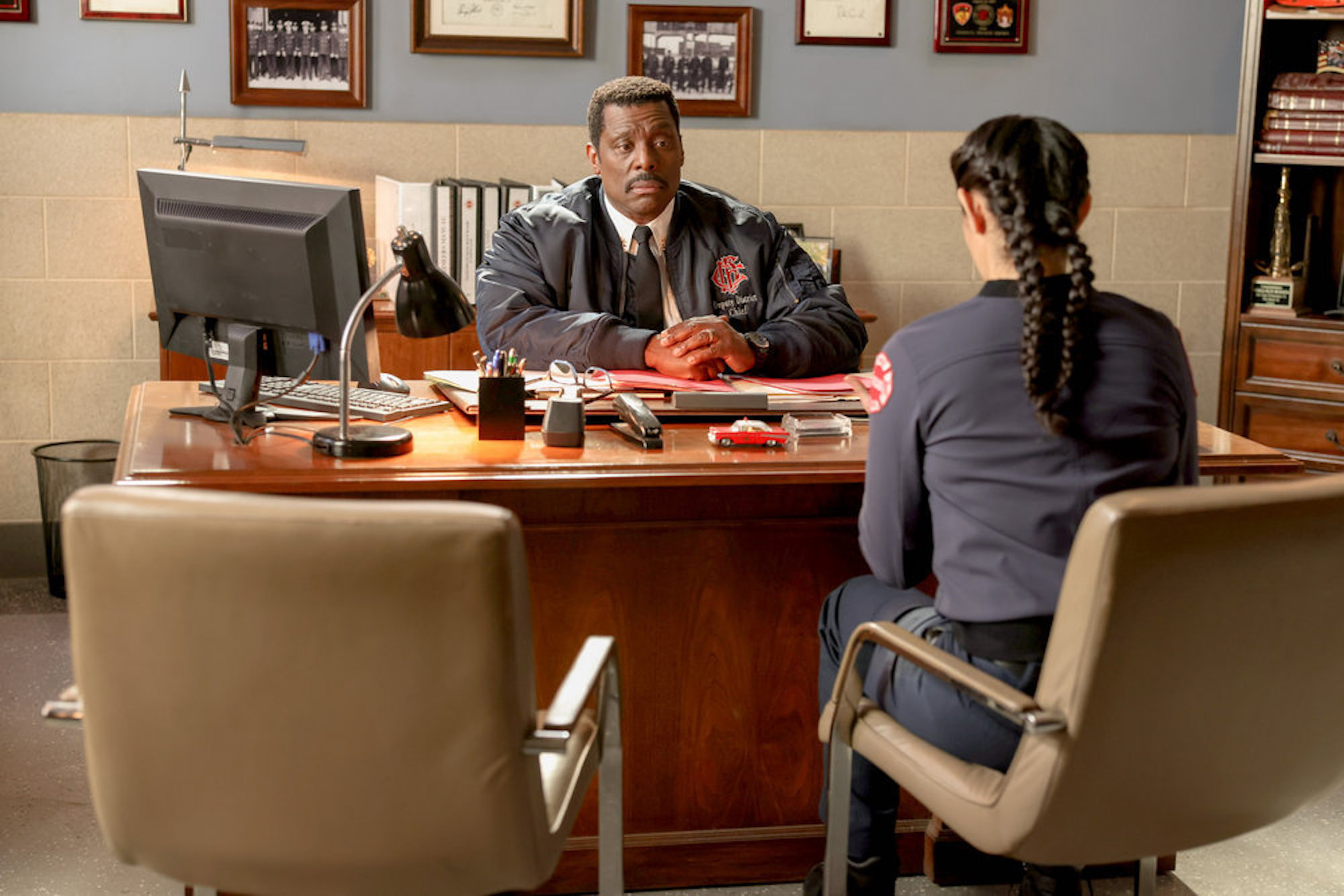 Wallace Boden and Stella Kidd in 'Chicago Fire' Season 10 Episode 14. They're sitting across from each other in Boden's office