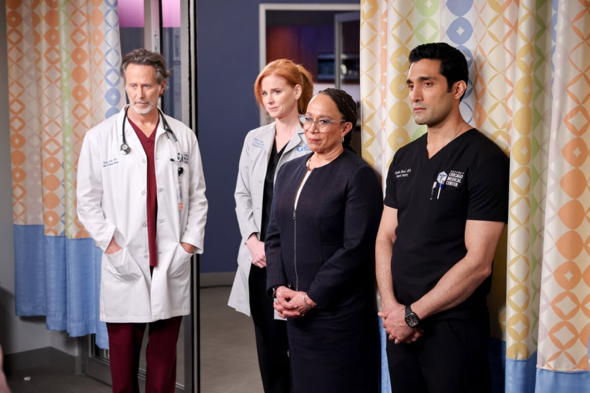 Archer, Blake, Goodwin, and Crockett stand in a patient's room in Chicago Med Season 7.