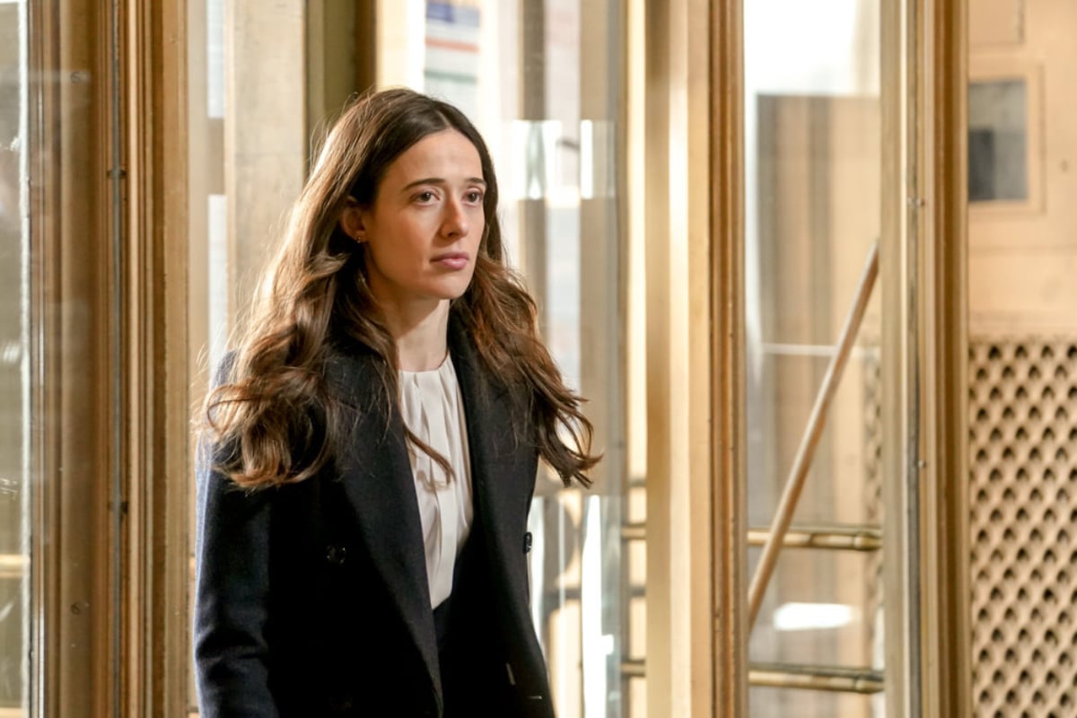 Marina Squerciati as Kim Burgess in Chicago P.D. Season 9. Burgess wears a white shirt and black coat.