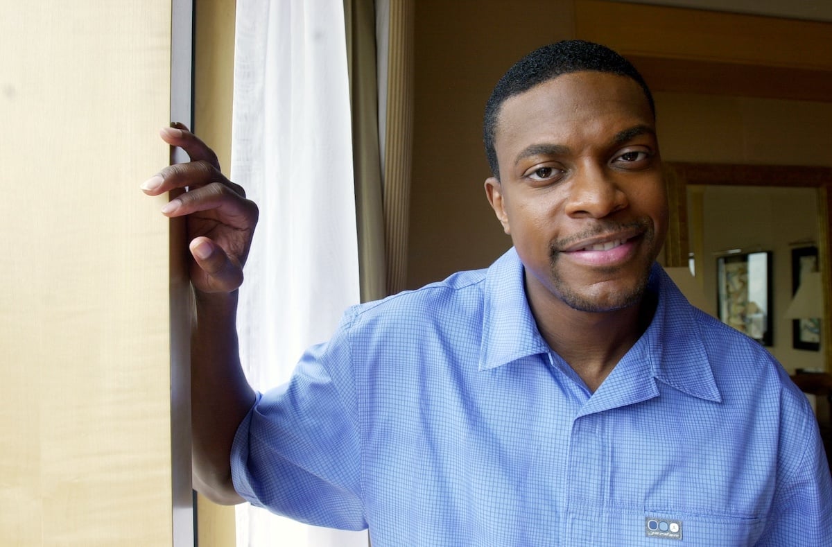 'Rush Hour' star Chris Tucker wears a blue shirt and poses