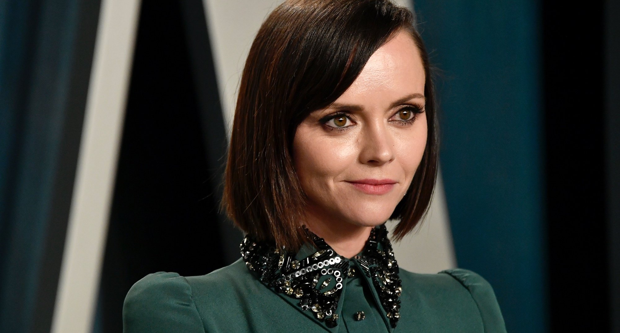 Christina Ricci for 'Wednesday' Tim Burton series wearing green collared dress.