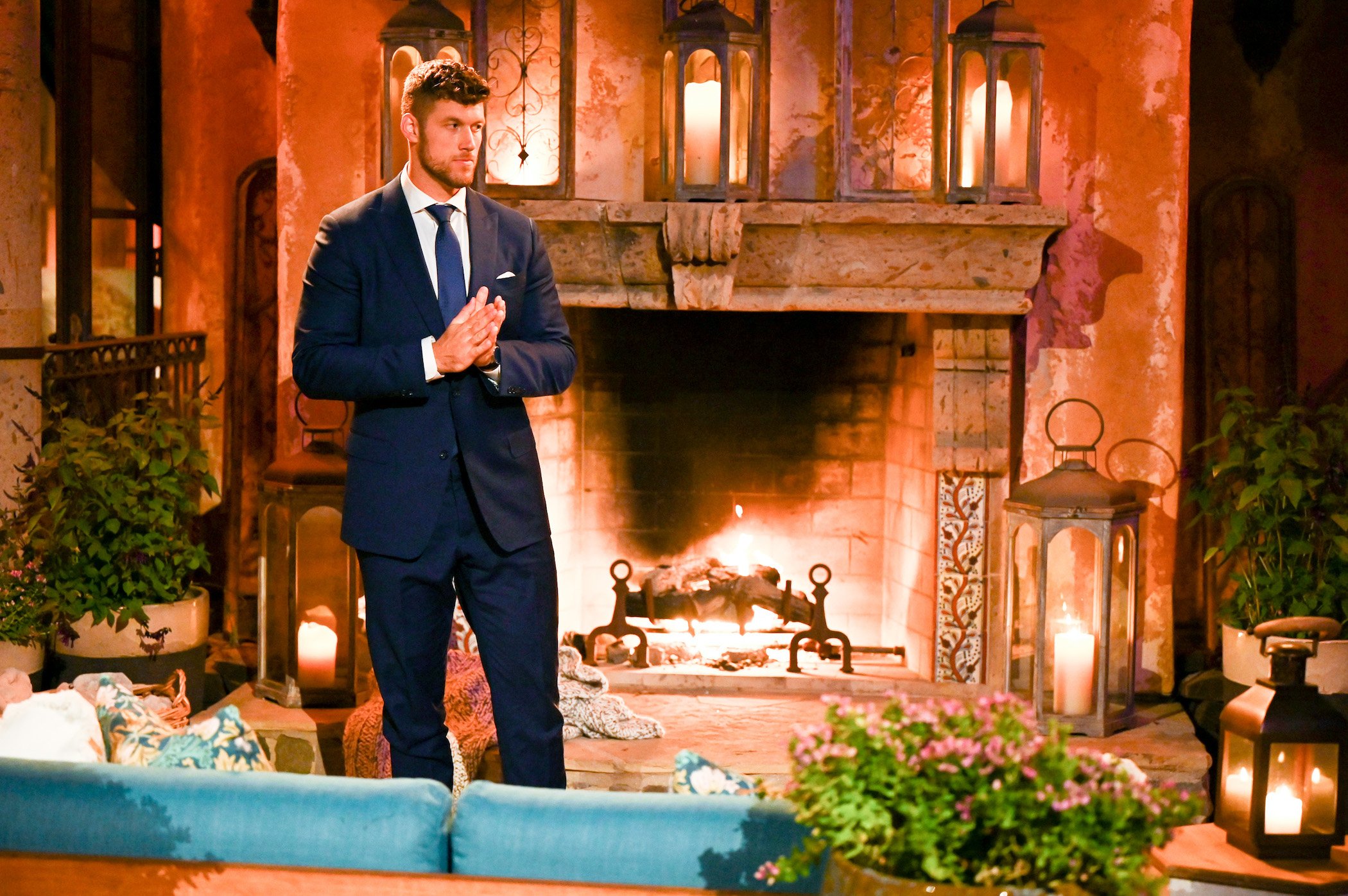 'The Bachelor' lead Clayton Echard standing alone in the 'Bachelor' mansion wearing a suit