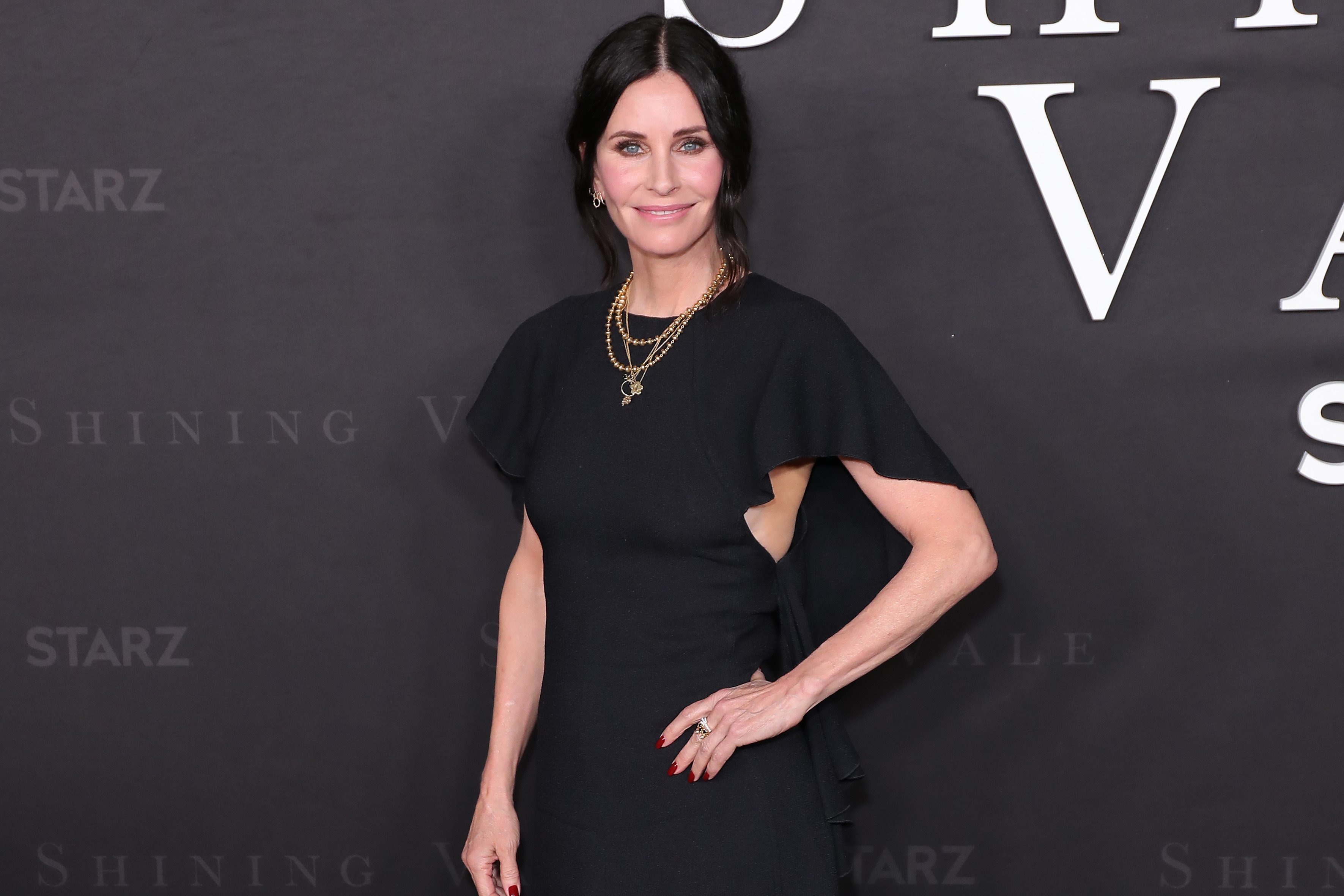 Courteney Cox poses for a photo with one hand on her hip at the premiere of 'Shining Vale'