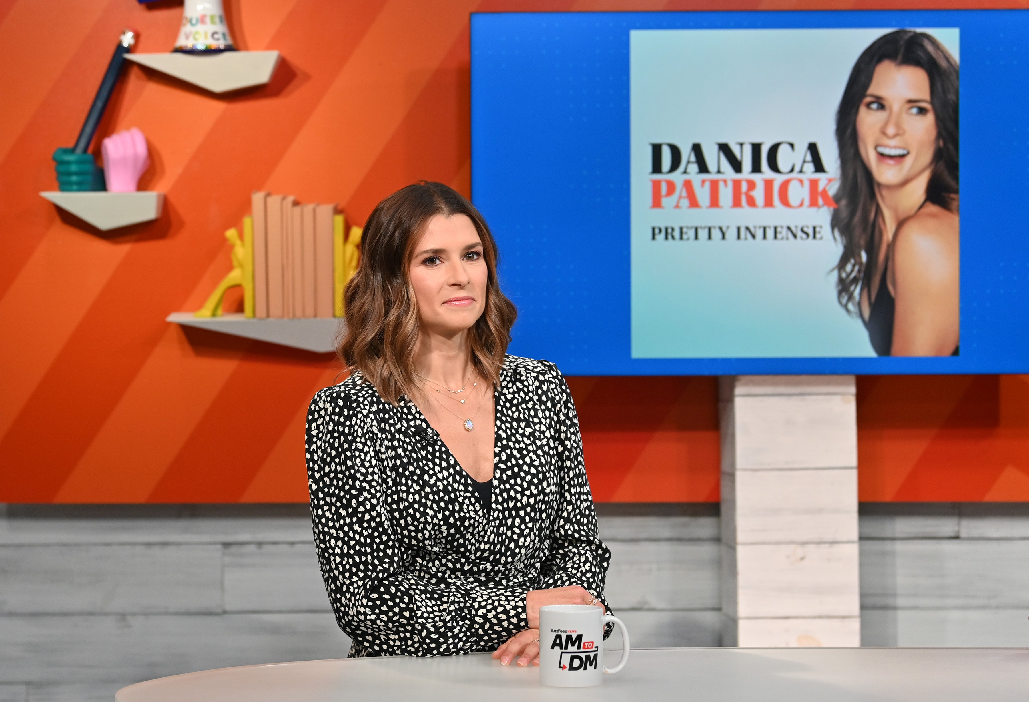 Danica Patrick speaking to a news outlet to promote her 'Pretty Intense' podcast