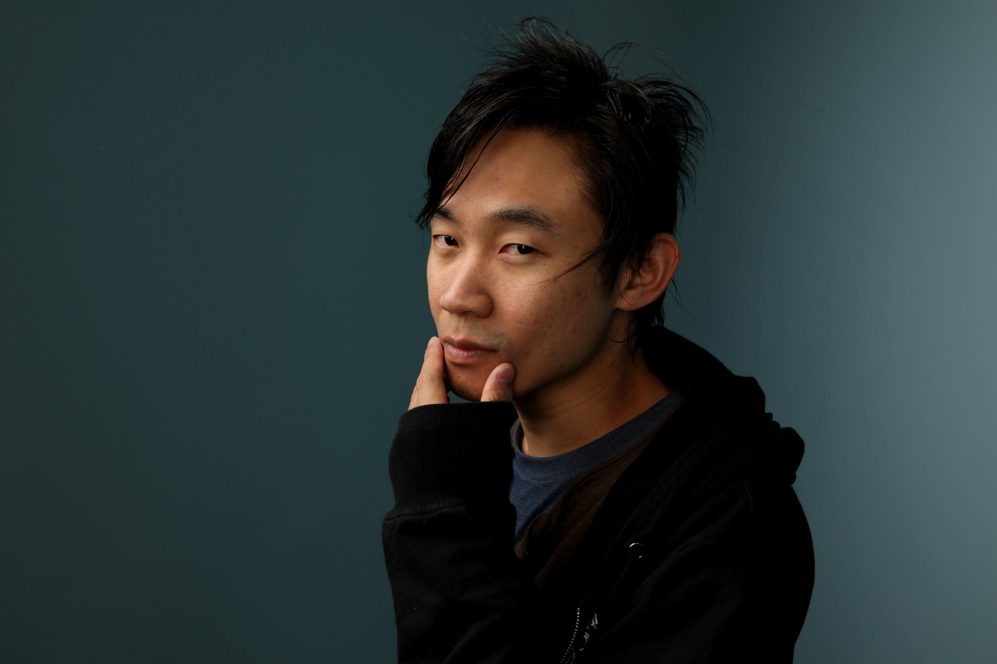 'Dead Silence' filmmaker James Wan posing with his fingers on his chin in portrait