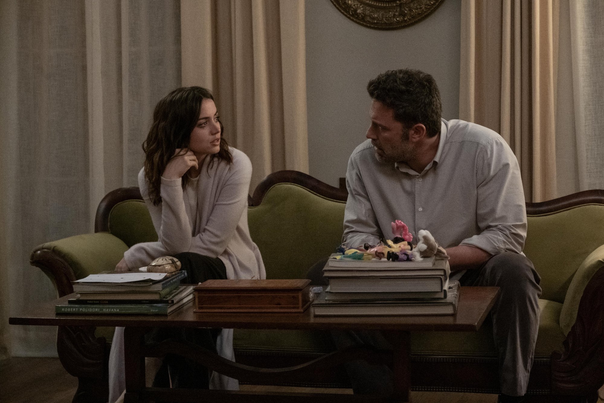 'Deep Water' Ana de Armas as Melinda Van Allen and Ben Affleck as Vic Van Allen sitting on a couch looking at each other