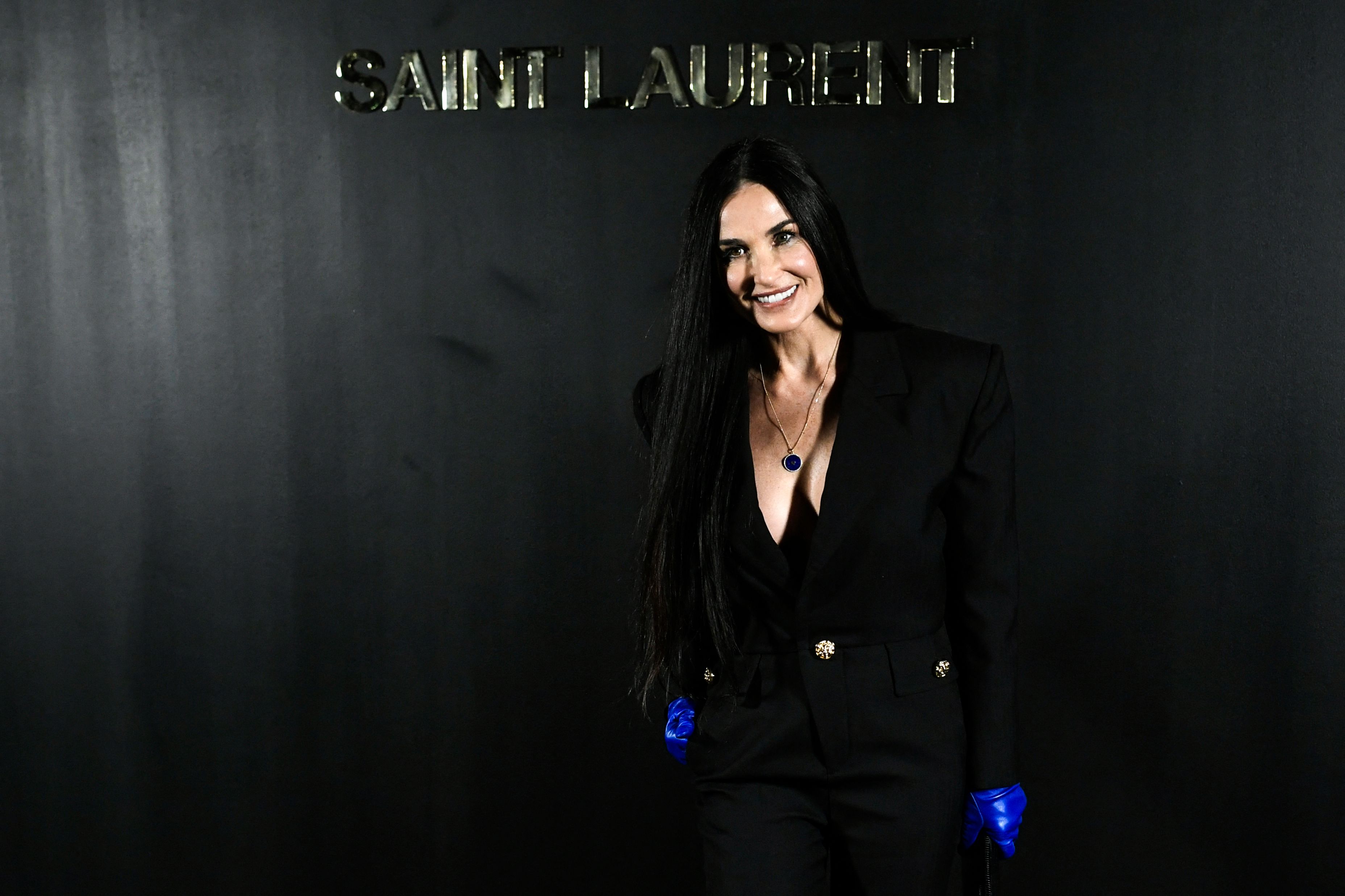 Demi Moore, whose real name is Demi Gene Guynes and has been married three times, poses for a photo at the Saint-Laurent Fall-Winter 2022-2023 show