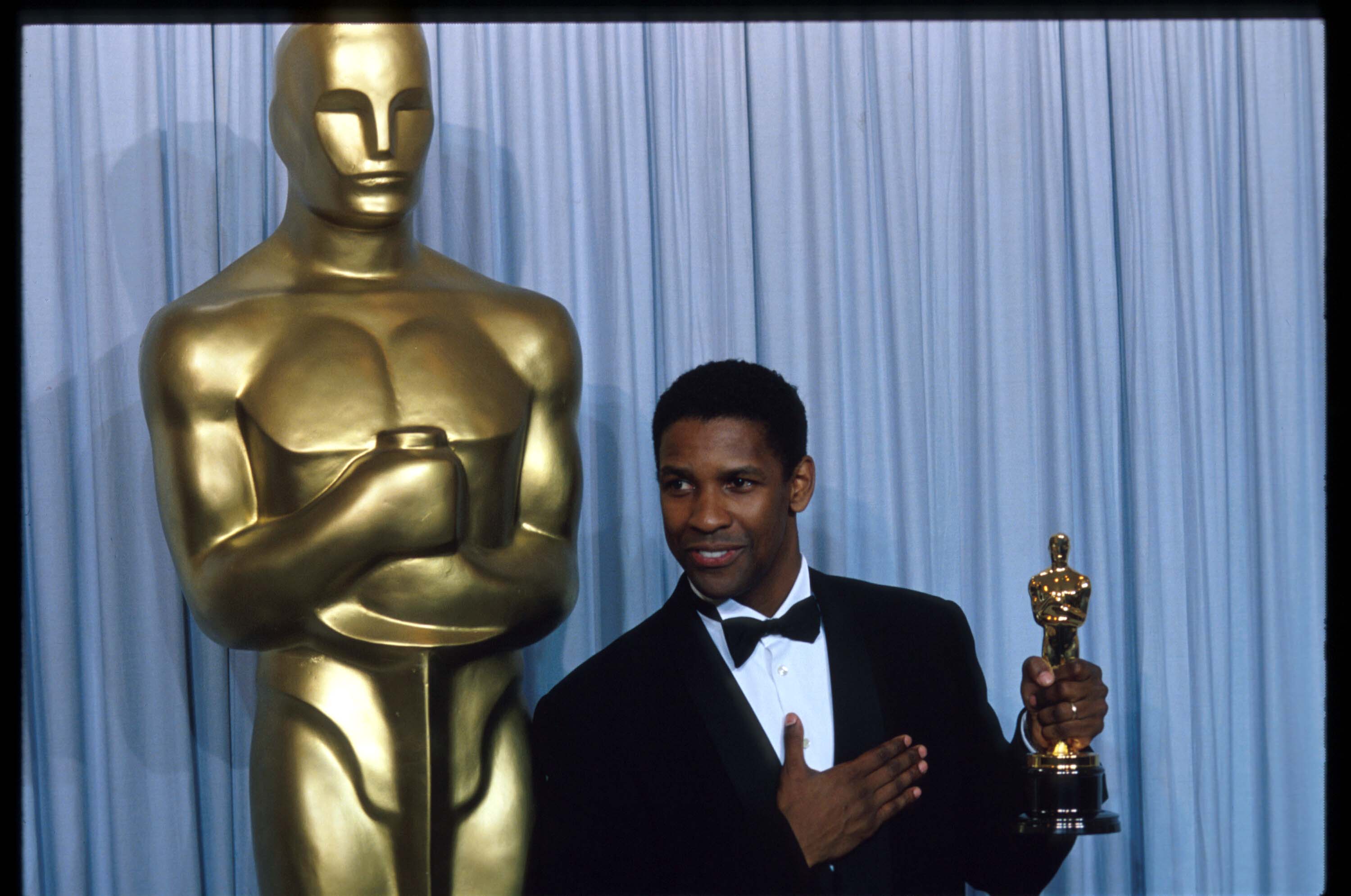 Denzel Washington stands backstage during the 62nd Academy Awards ceremony in 1990 after winning an Oscar for Best Actor in a Supporting Role for Glory