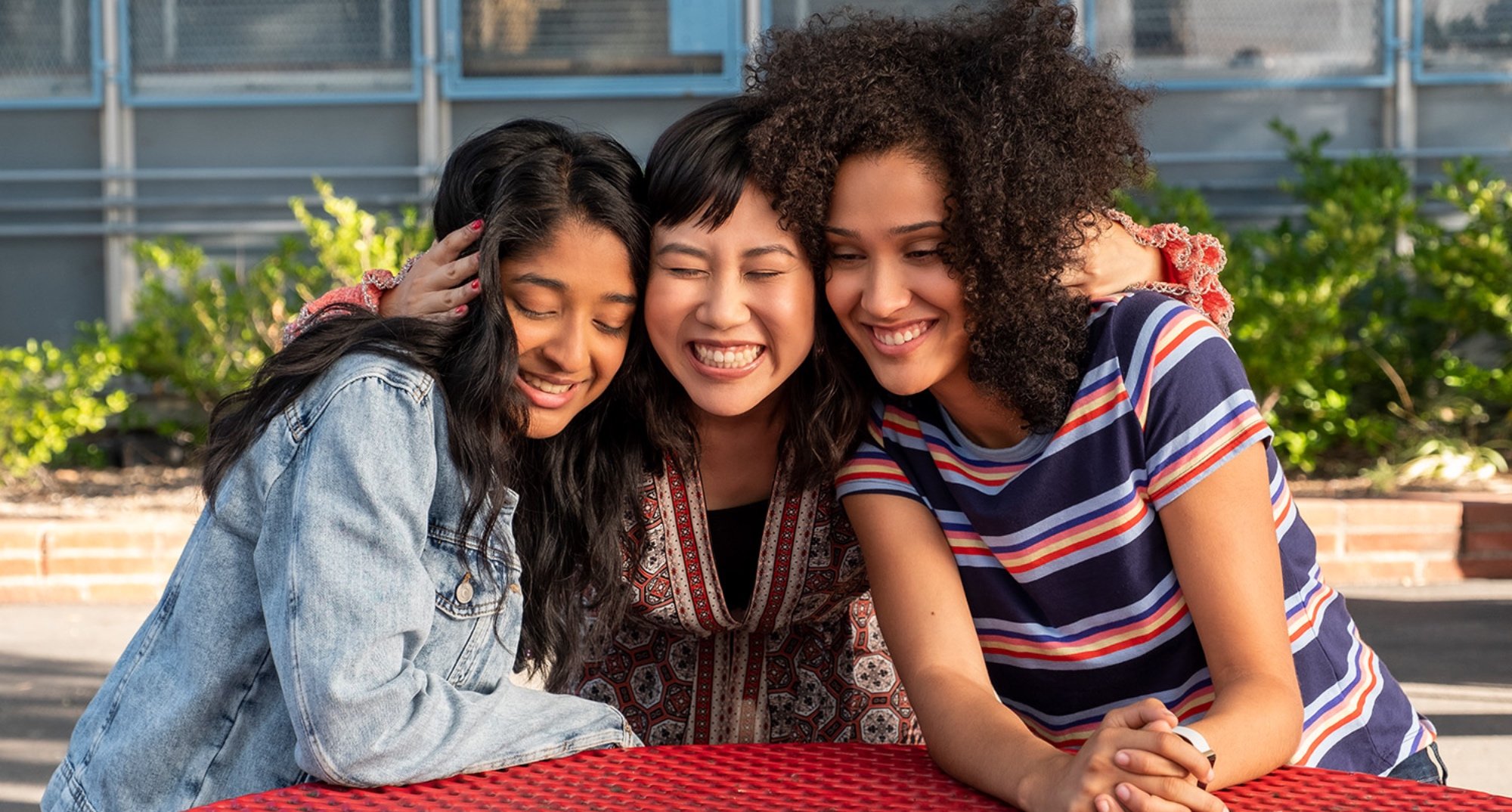 Devi, Eleanor and Fabiola from 'Never Have I Ever' hugging in relation to Season 4.