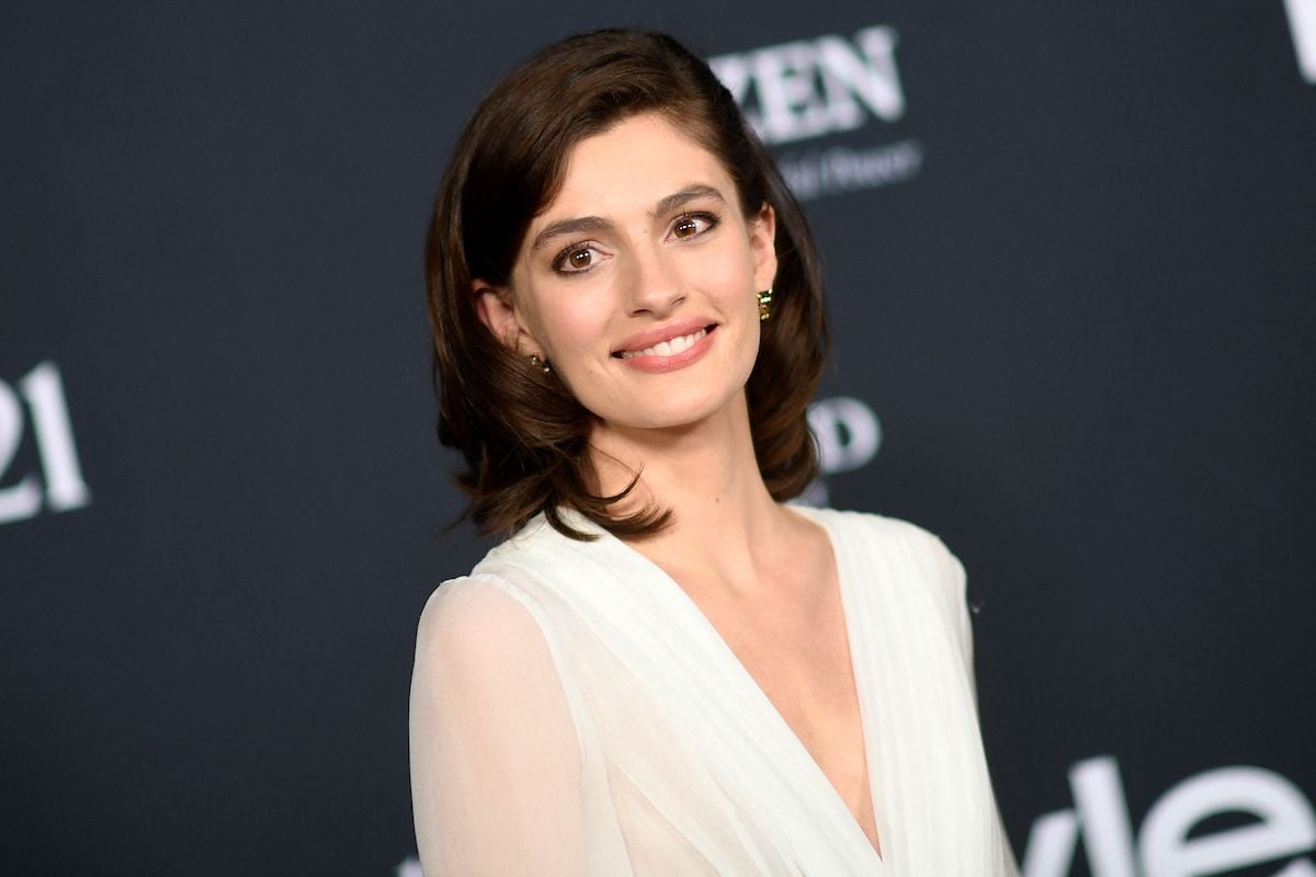 Actress Diana Silvers wears a white gown on the red carpet for the 2021 InStyle Awards