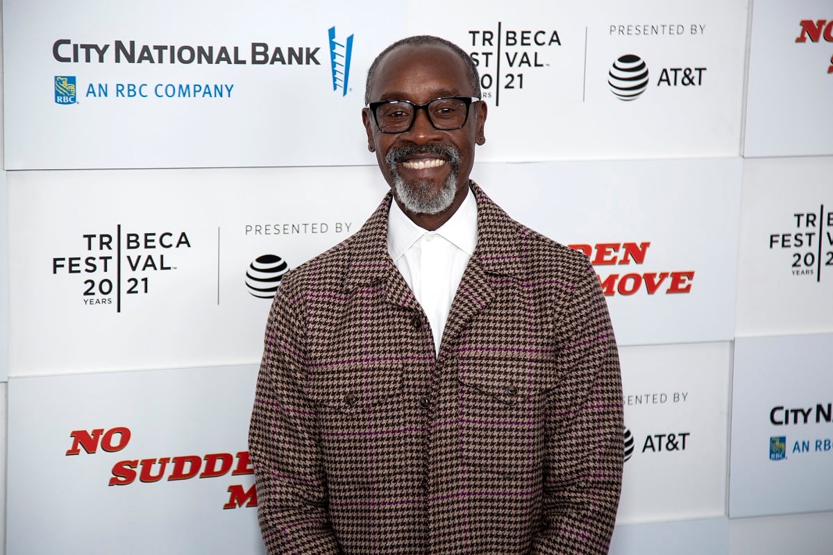 Don Cheadle smiling while wearing a gray jacket.