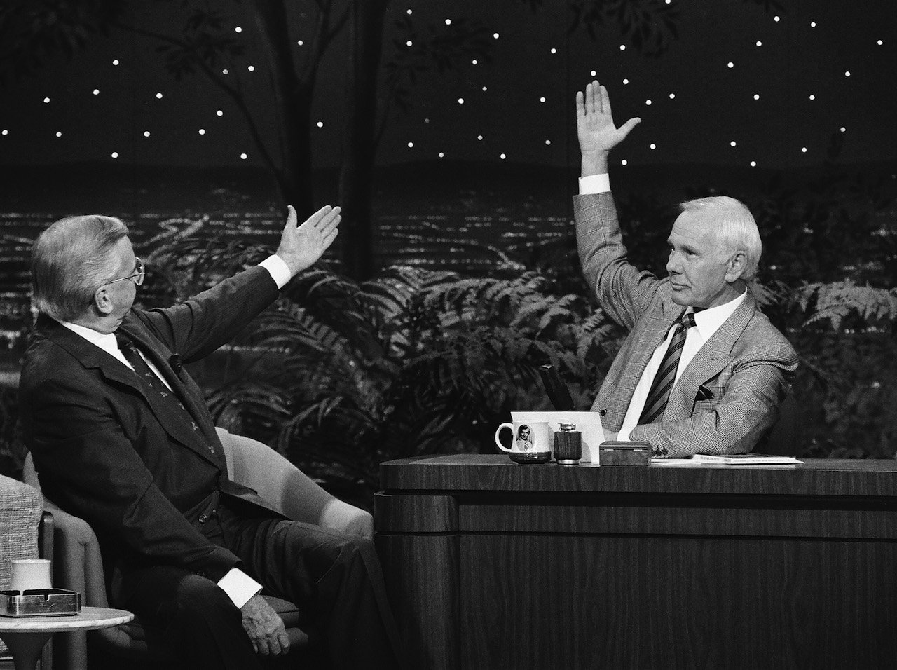 (L-R) Ed McMahon raising a hand toward Johnny Carson, also raising his hand, on 'The Tonight Show' in 1990