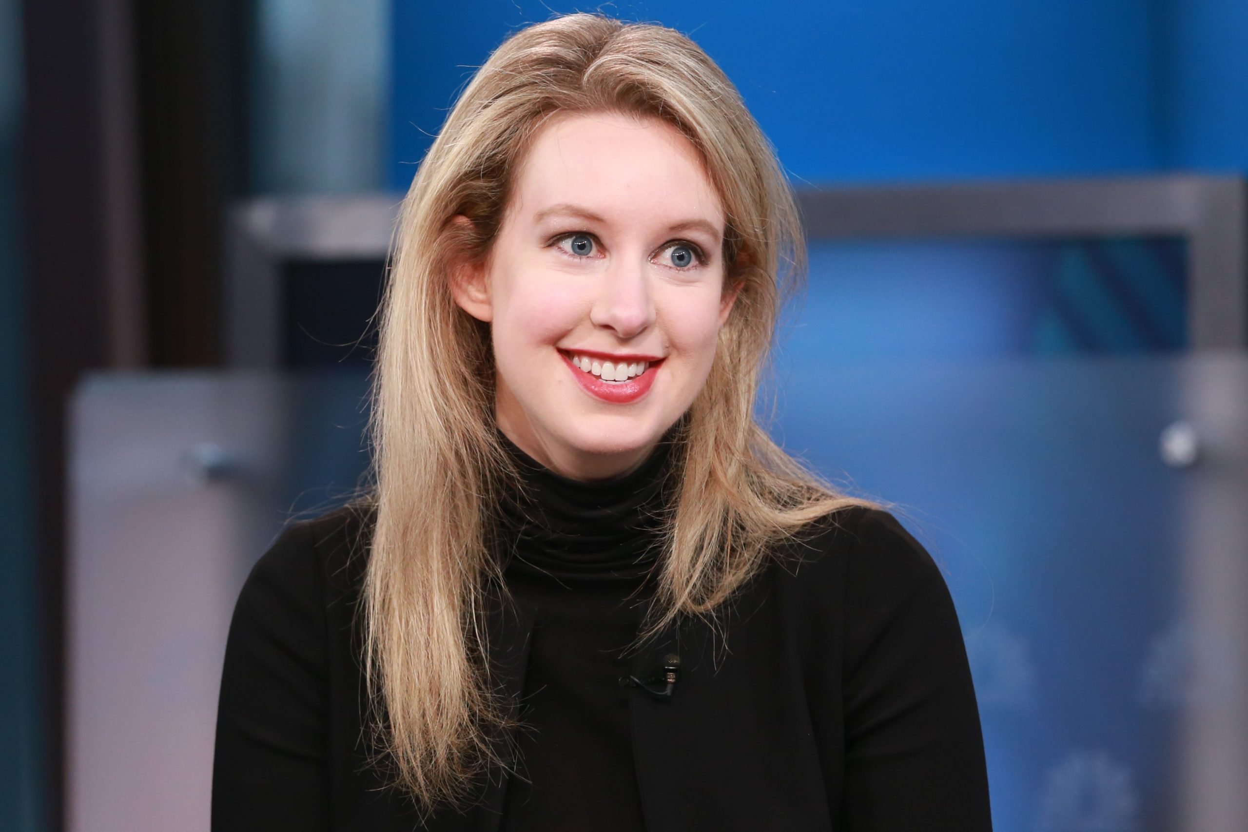 Elizabeth Holmes smiling in a black turtleneck