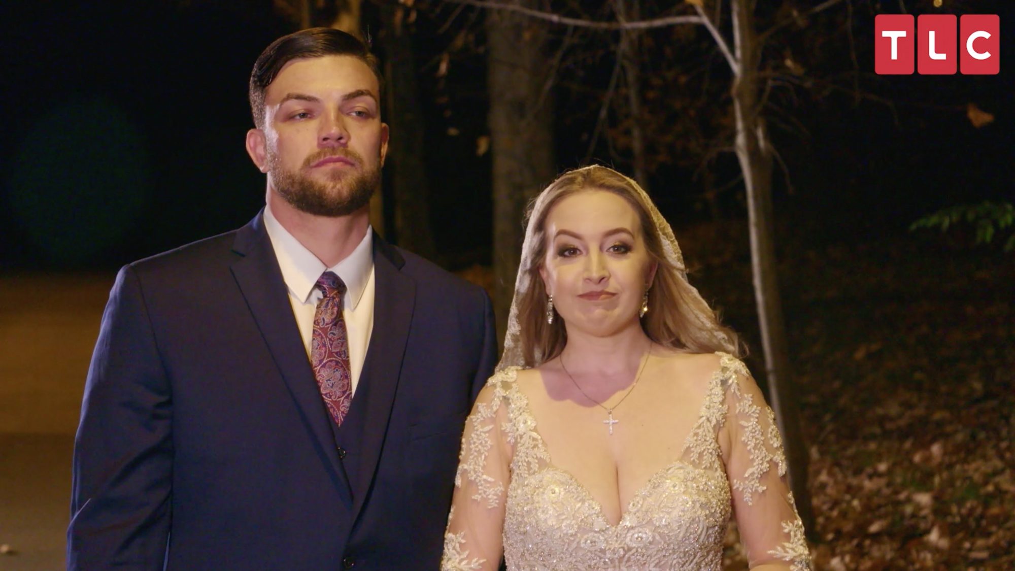 Elizabeth Potthast wearing a wedding dress and Andrei Castravet wearing a tux on their wedding day on '90 Day Fiance'.