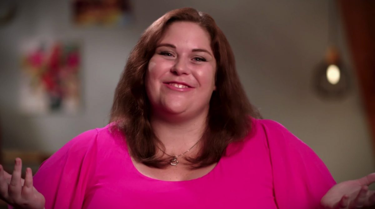 Ella Johnson wearing a bright pink shirt, shrugs during an interview for '90 Day Fiancé: Before the 90 Days' Season 5. 