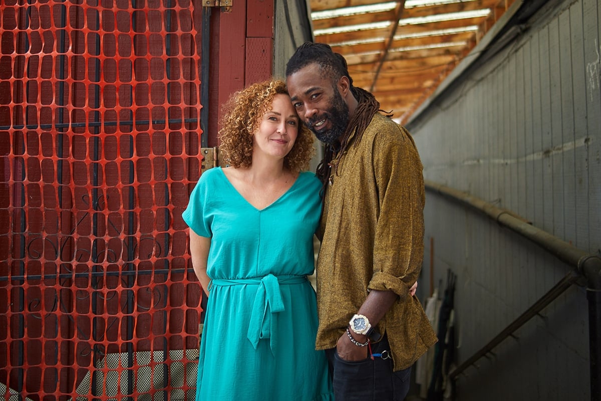 Ellie wearing a turquoise dress standing with her fiancé, Victor, who is wearing a brown shirt in Providencia, Colombia on '90 Day Fiancé: The Other Way' Season 3.  