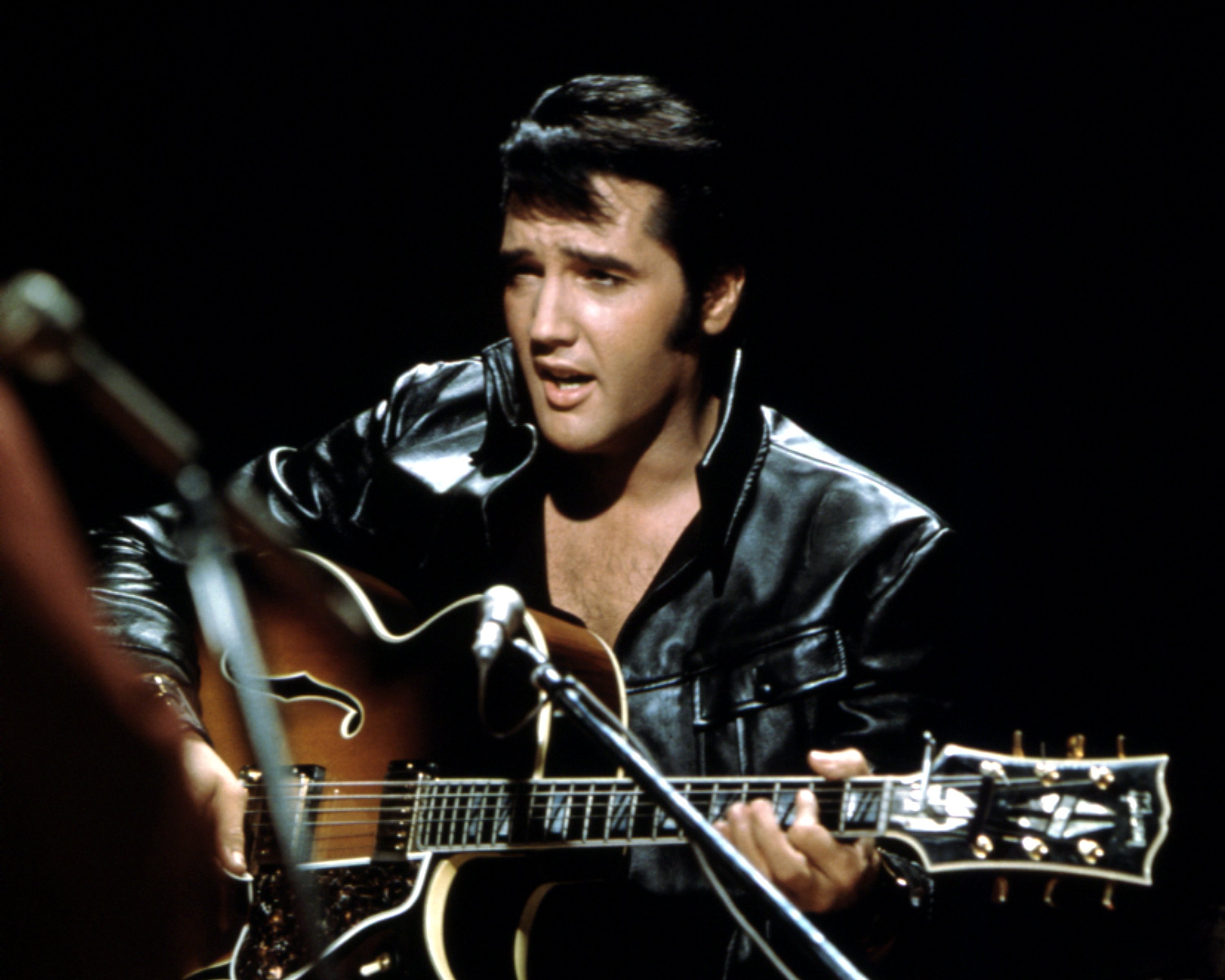 Elvis Presley playing songs on a guitar in the ''68 Comeback Special'