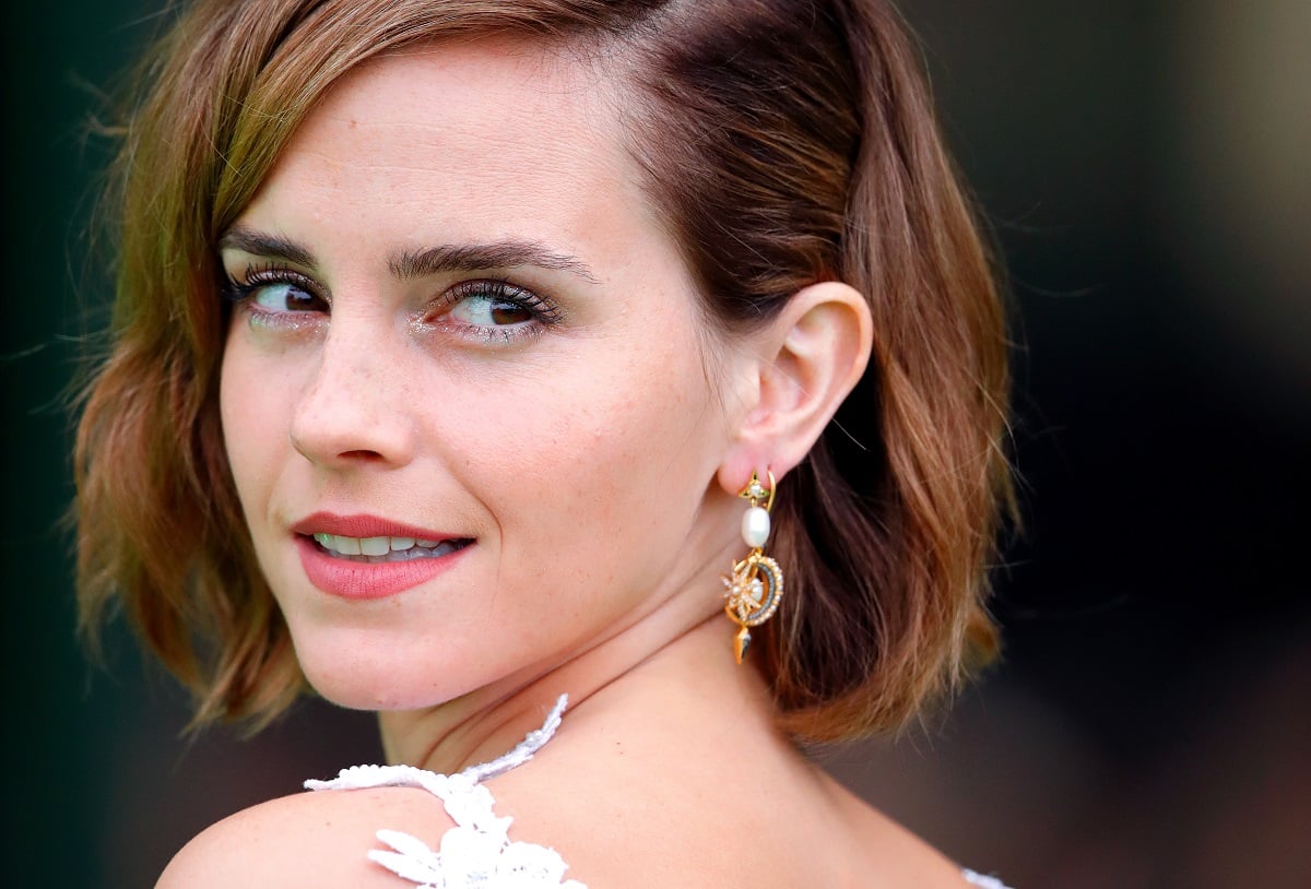 Emma Watson looking back smiling.
