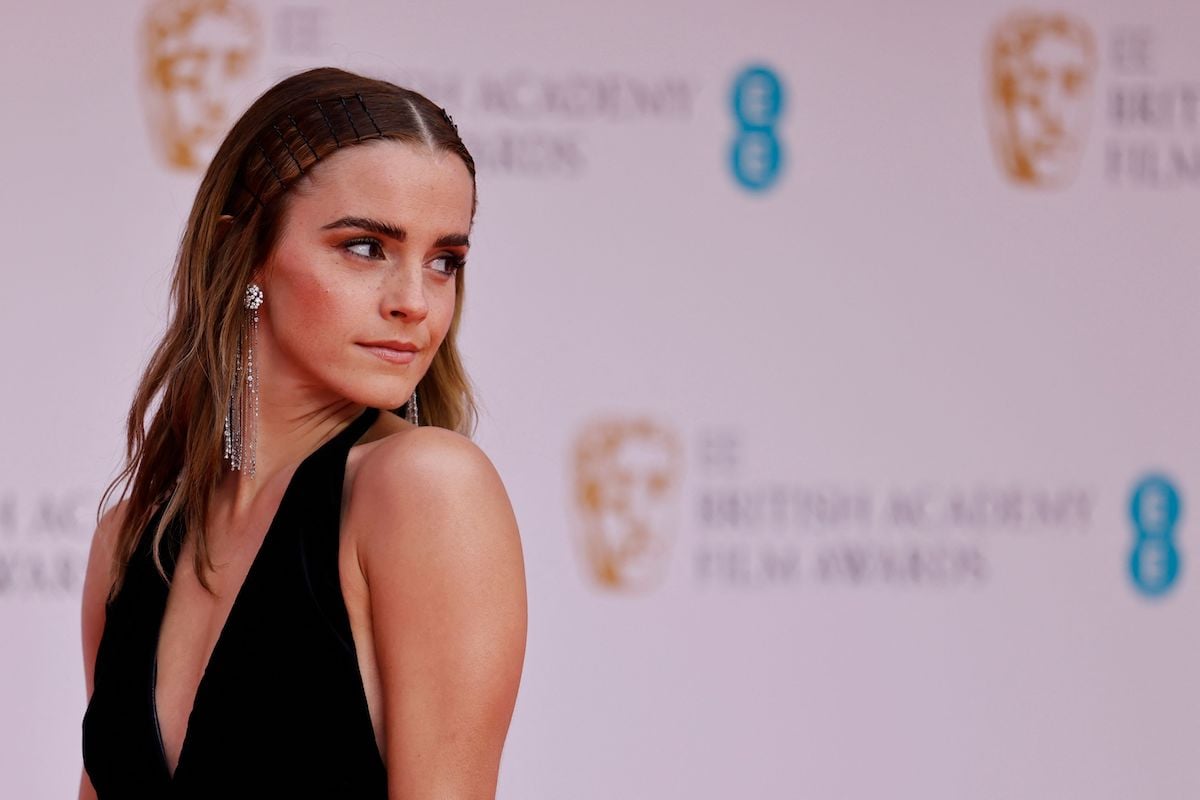 Harry Potter alum Emma Watson (who portrayed Hermione Granger) on the red carpet for the BAFTA awards as she looks over her shoulder