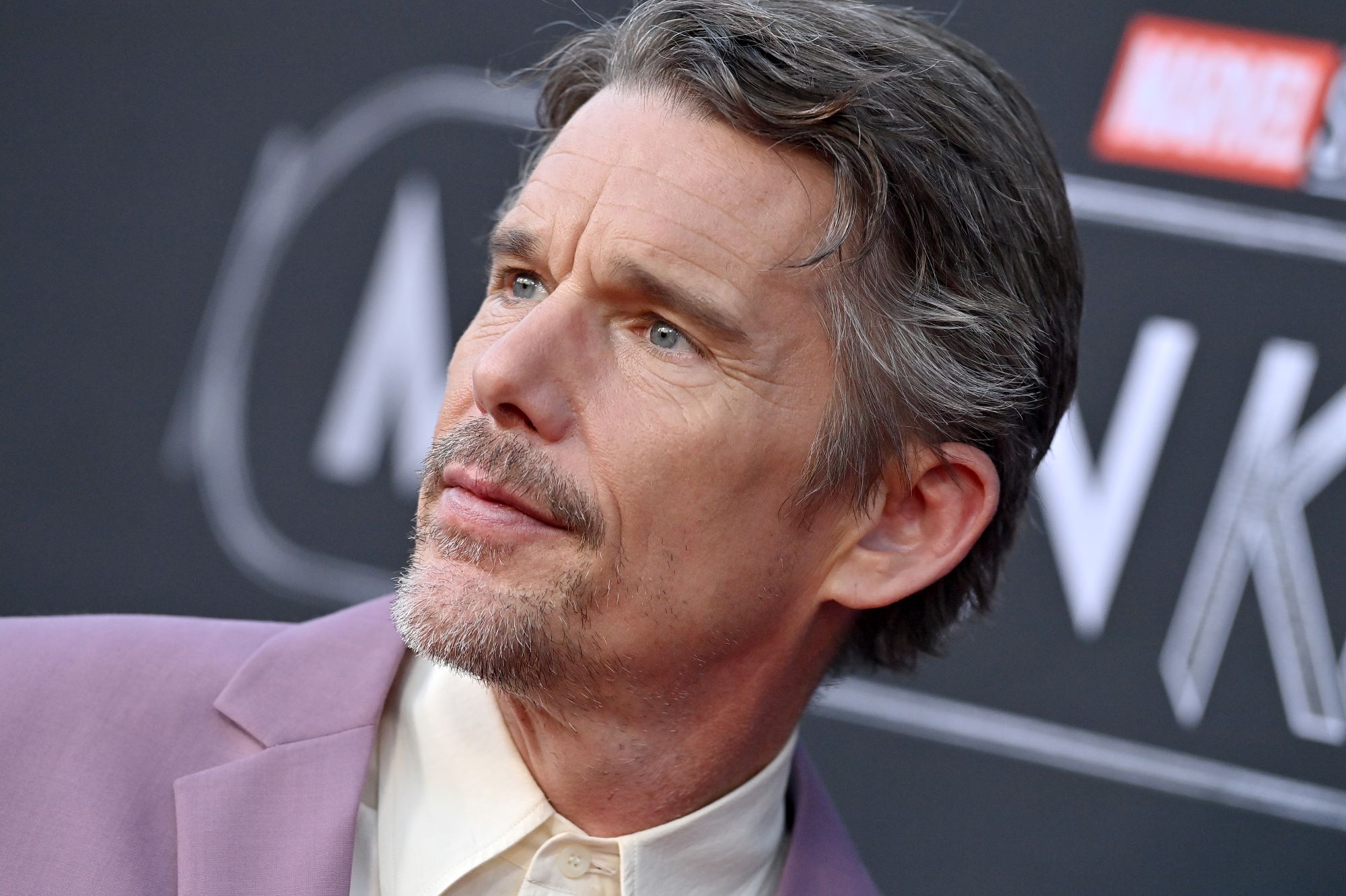 Ethan Hawke, star of 'Moon Knight,' which probably won't get a season 2, wears a light purple suit over a white button-up shirt.