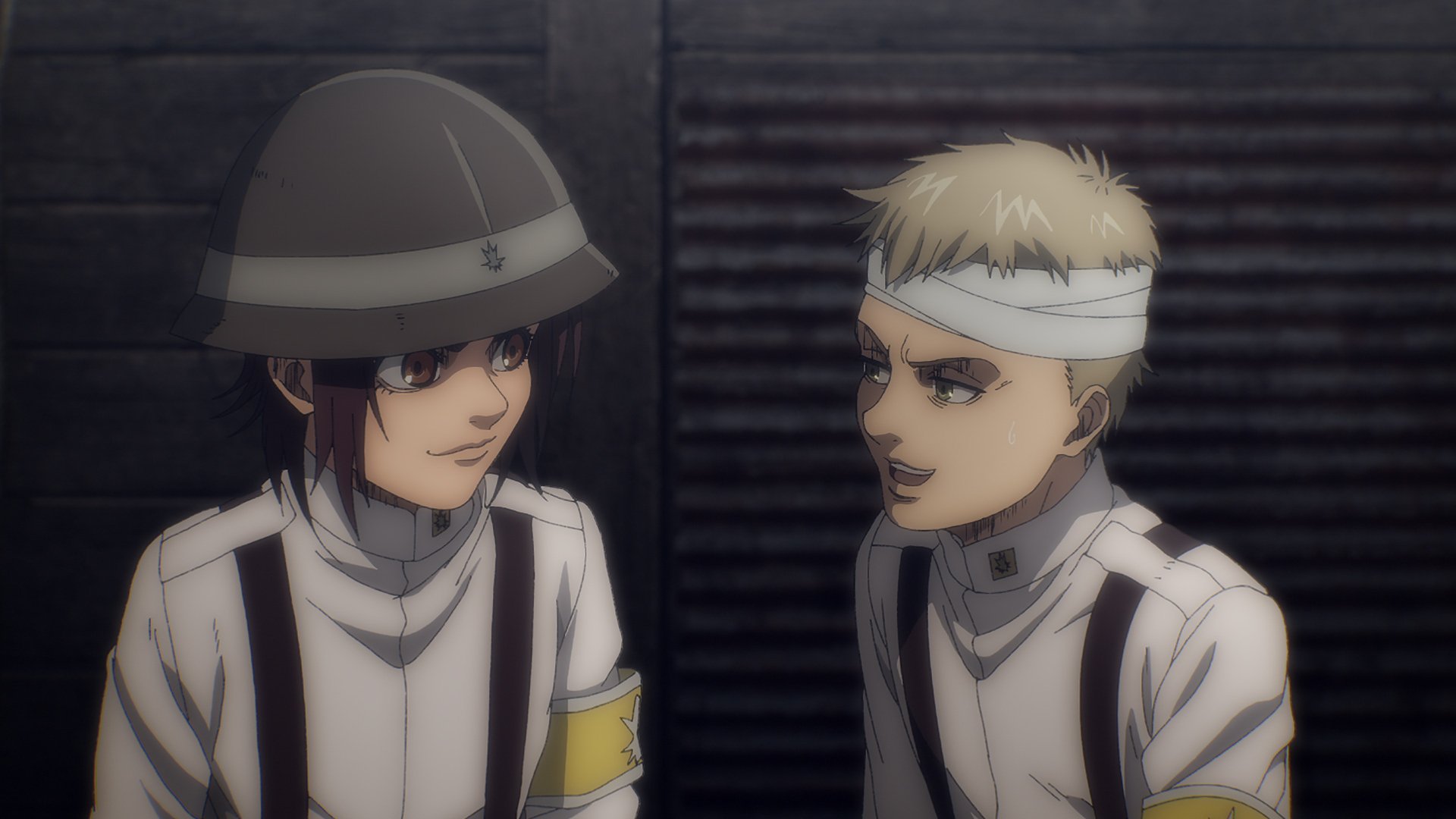Gabi and Falco in 'Attack on Titan' Season 4 Part 1. They're next to one another in the trenches. They're smiling at each other and Falco's head is bandaged.