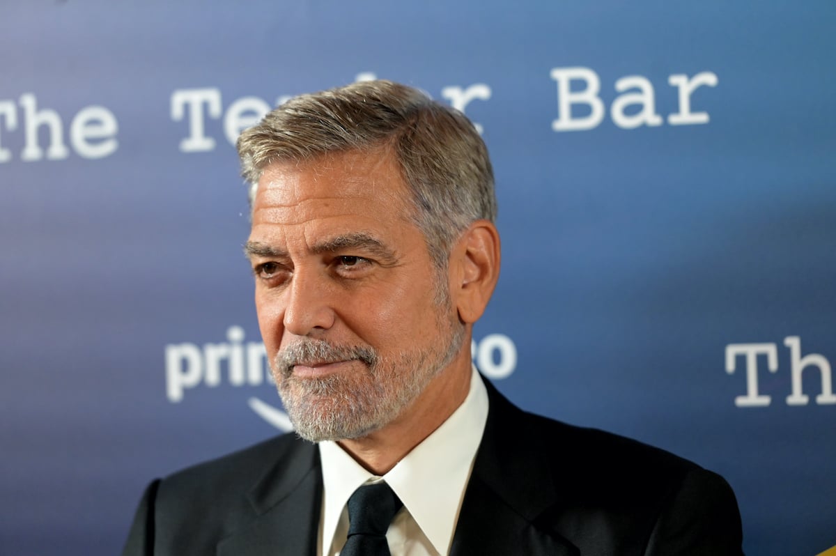 George Clooney in front of a blue background