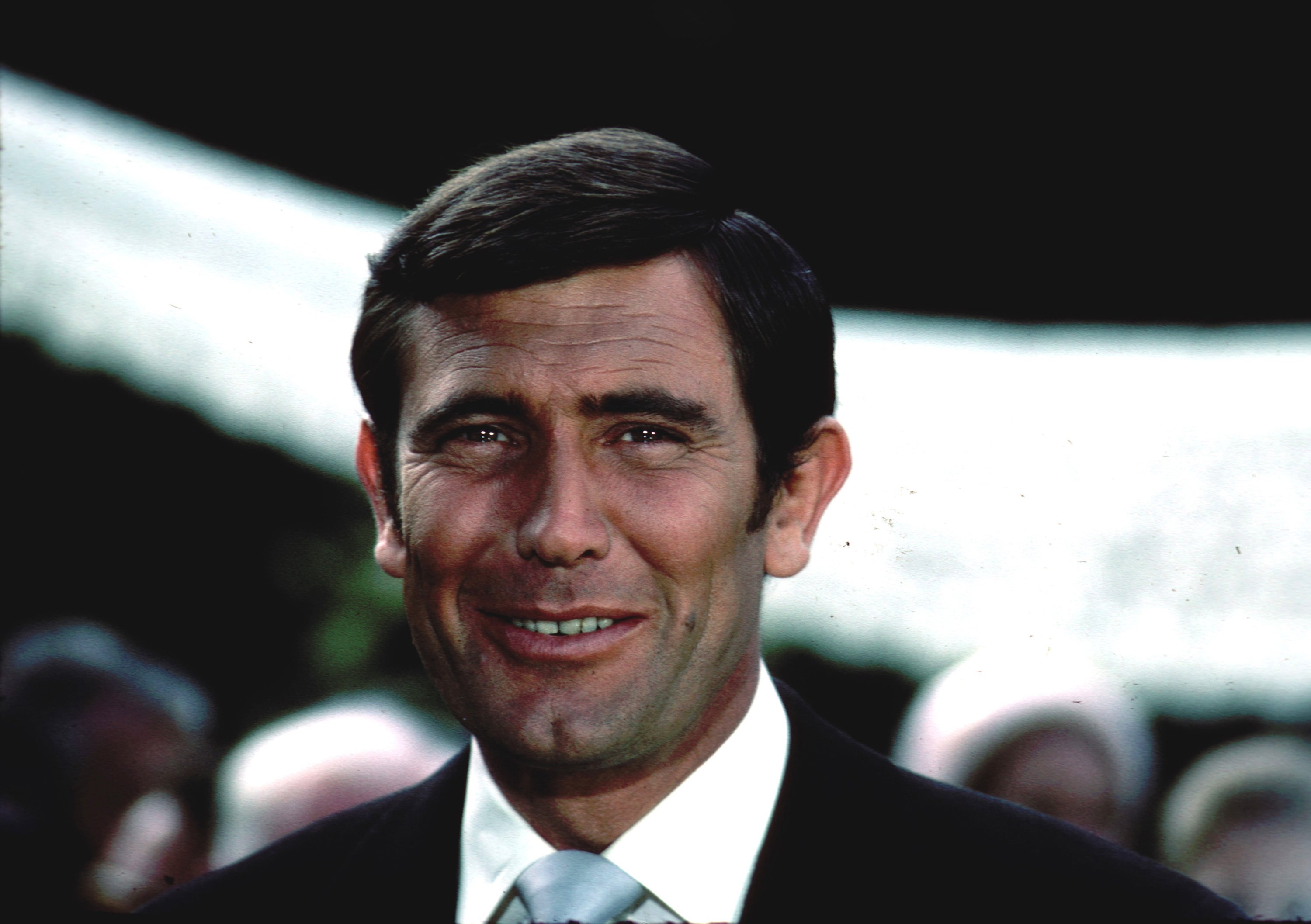 George Lazenby smiles during the filming of his 1969 James Bond film